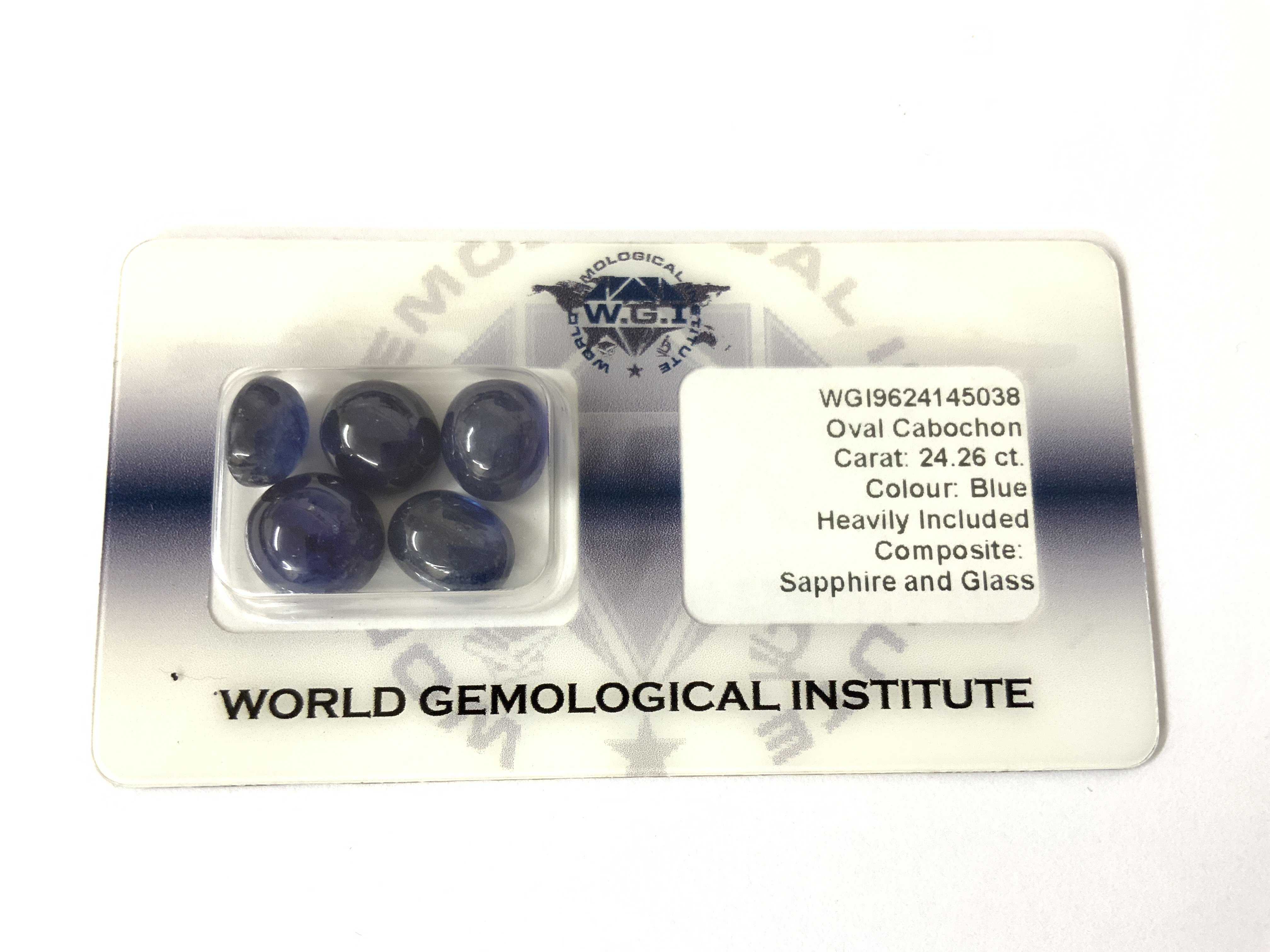 A certificated, security sealed parcel of 5 cabochon glass composite sapphires totalling 24.26ct, cert no WGI9624145038. Postage category A