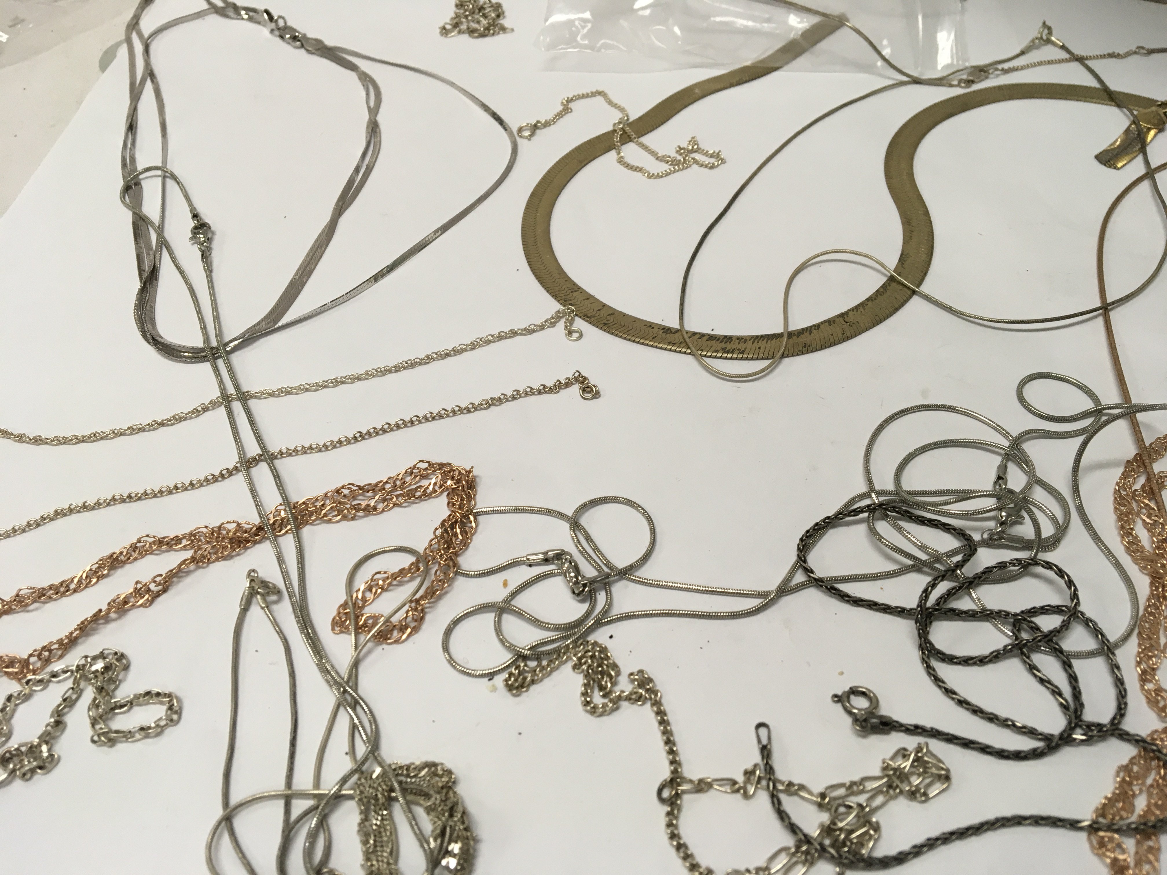 A collection of necklaces and bracelets including silver.