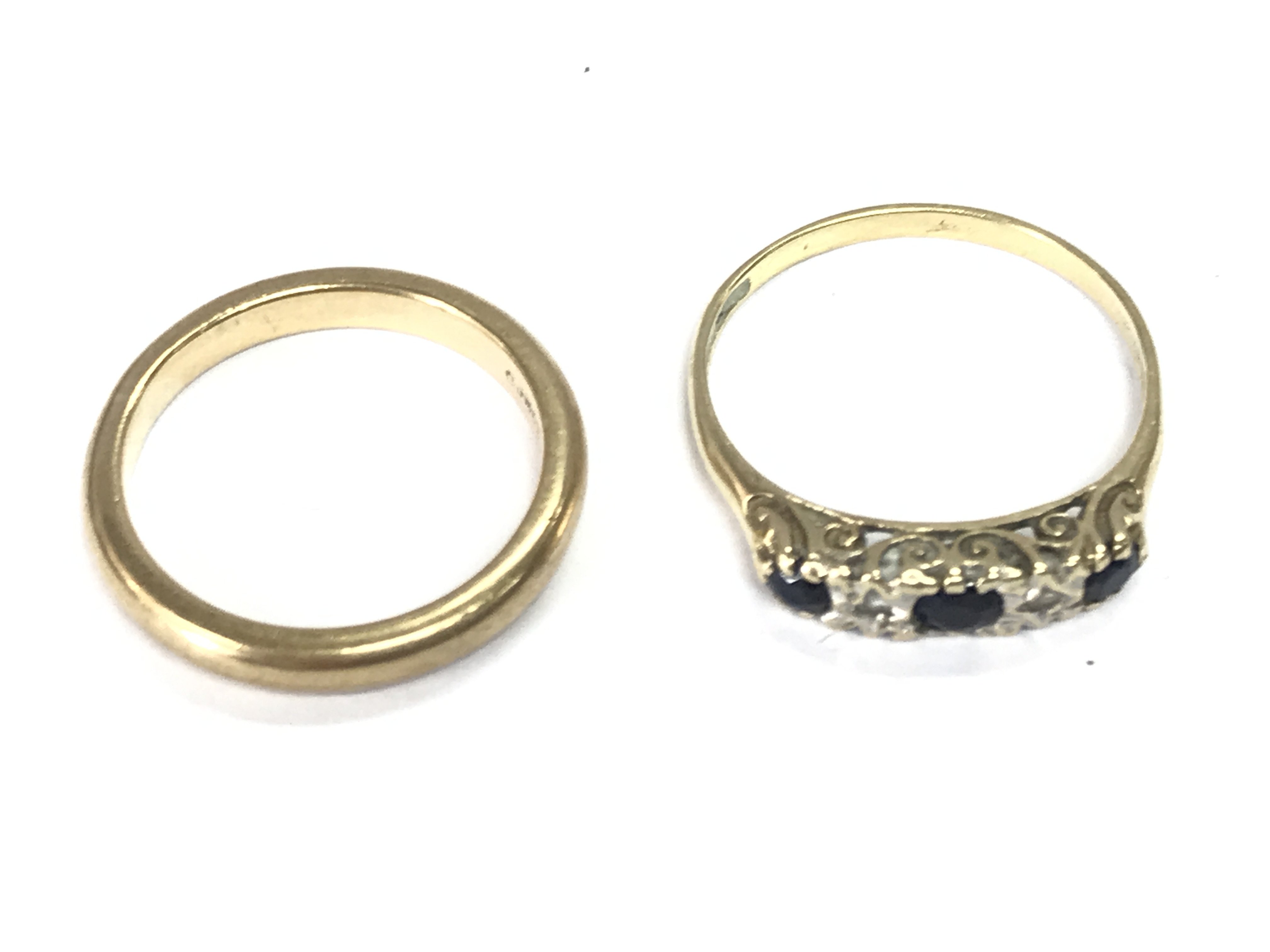 Two 9ct gold rings including a 9ct gold band. Size M and O. 4.80g Postage A