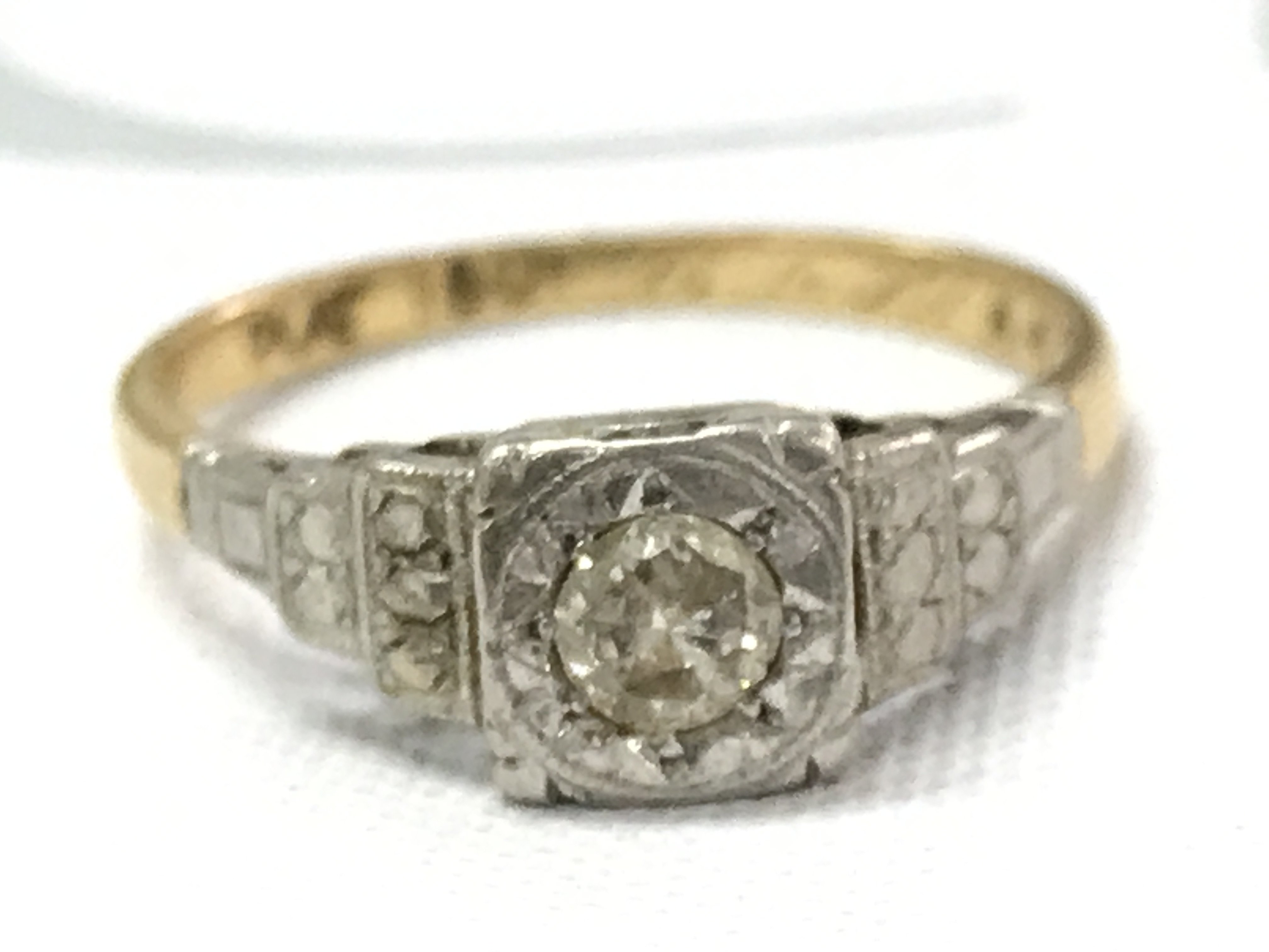 An 18ct gold and platinum ring, approximately 0.25ct. Size N/O. 2.7g total weight Postage category A