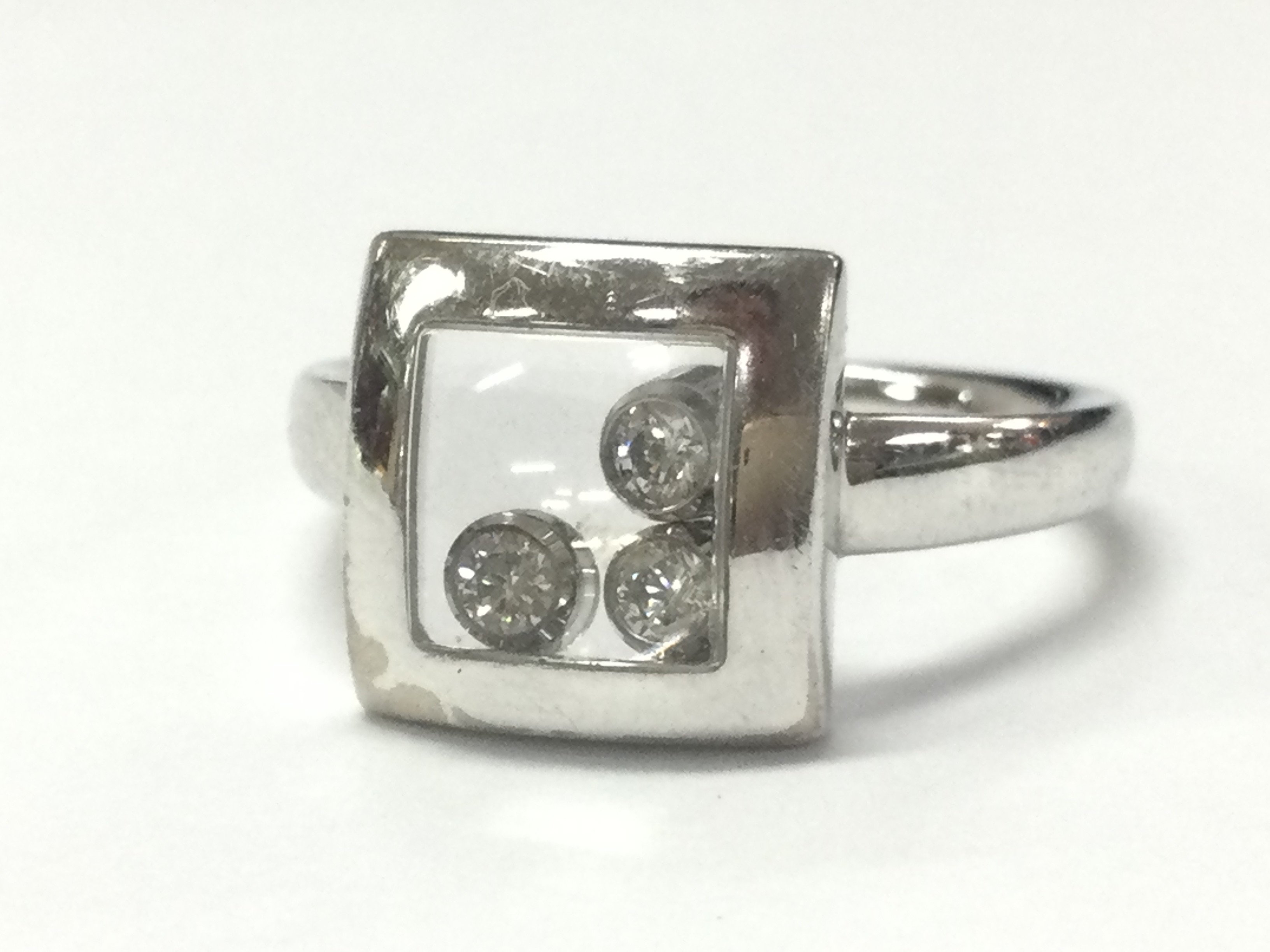 A boxed 18ct white gold Chopard happy moving diamonds ring with certificate , 7.7g total weight. Postage category A