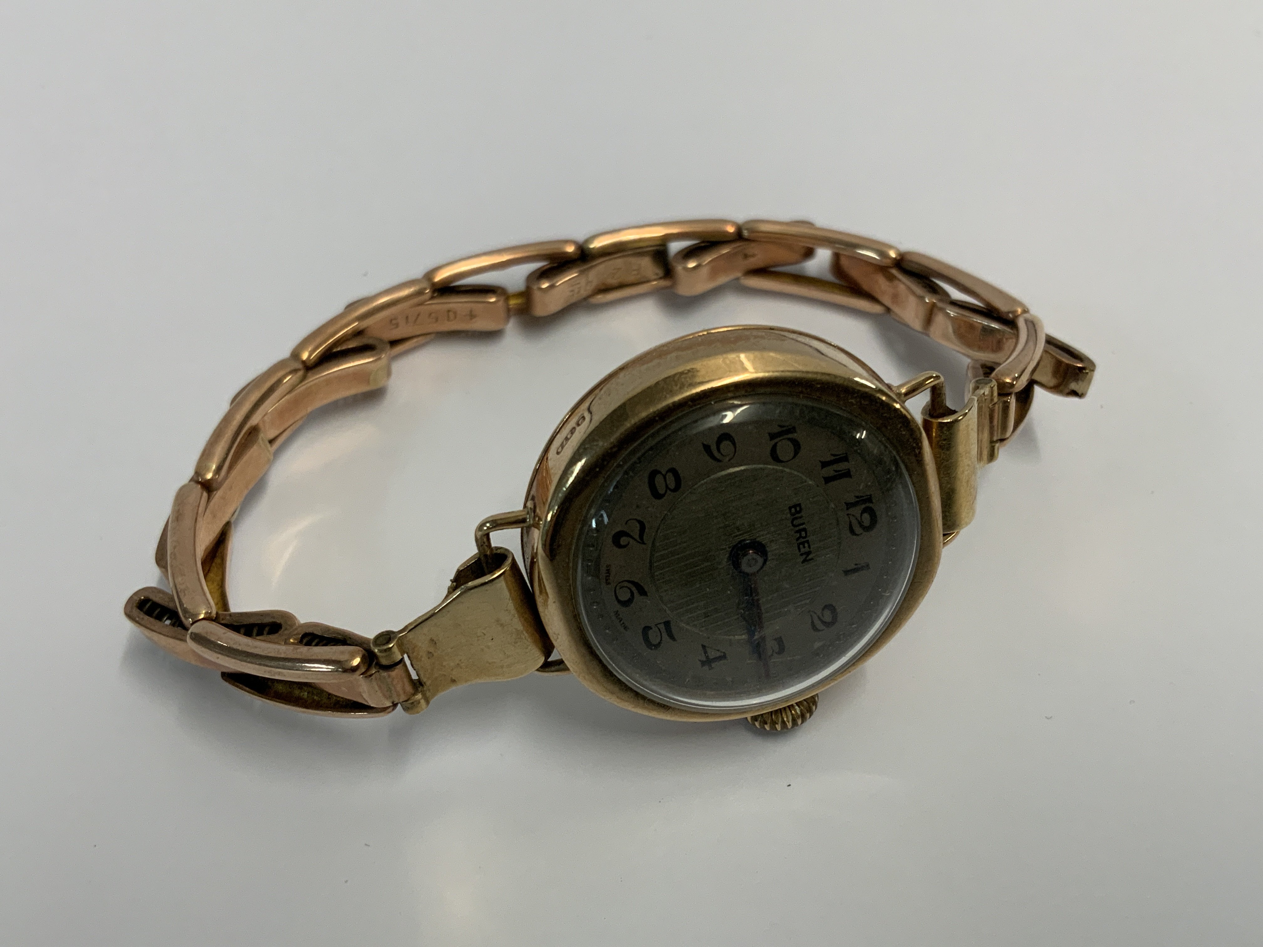 A 9ct gold Buren wristwatch with expanding unmarked strap. (A)
