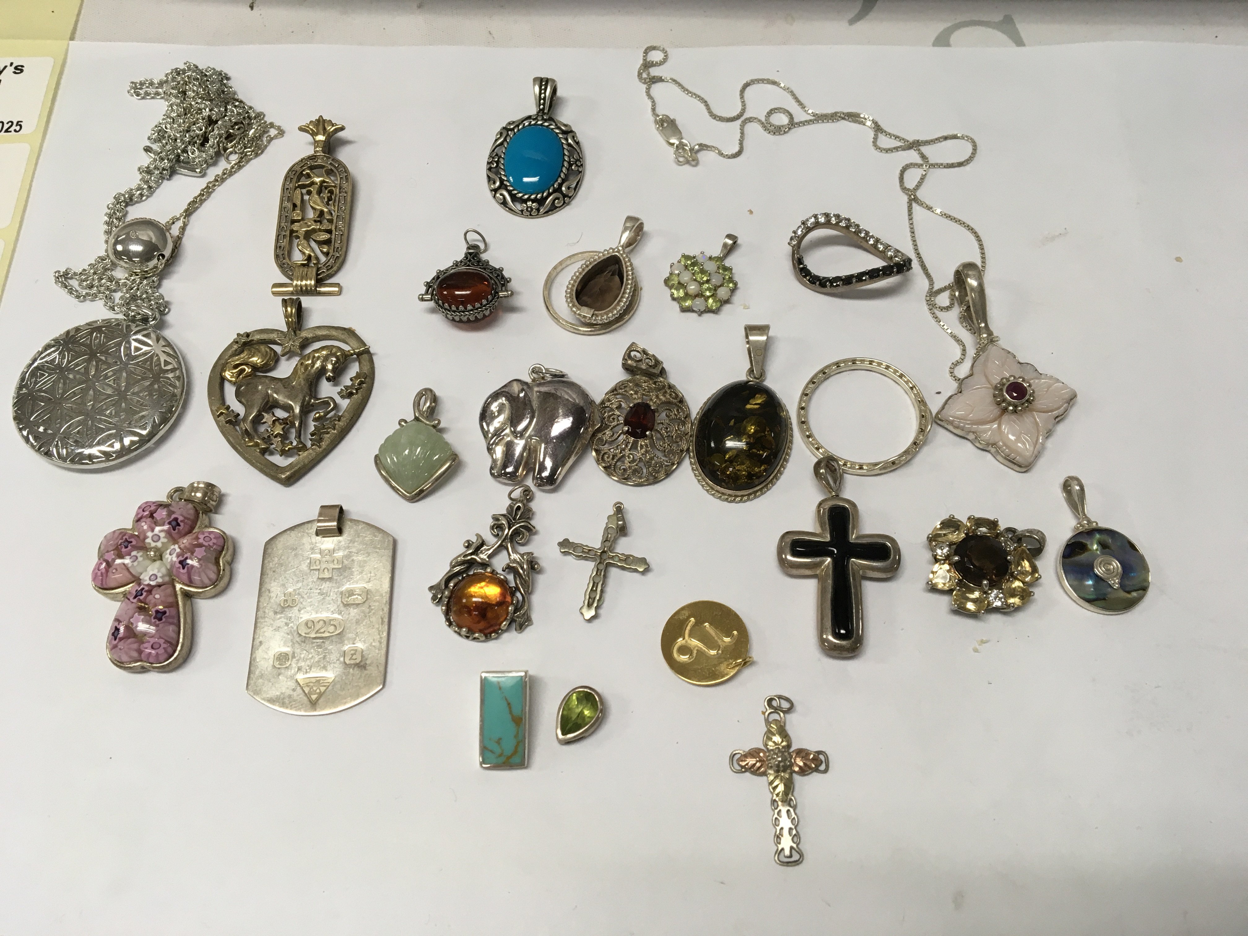 A collection of various silver pendants .
