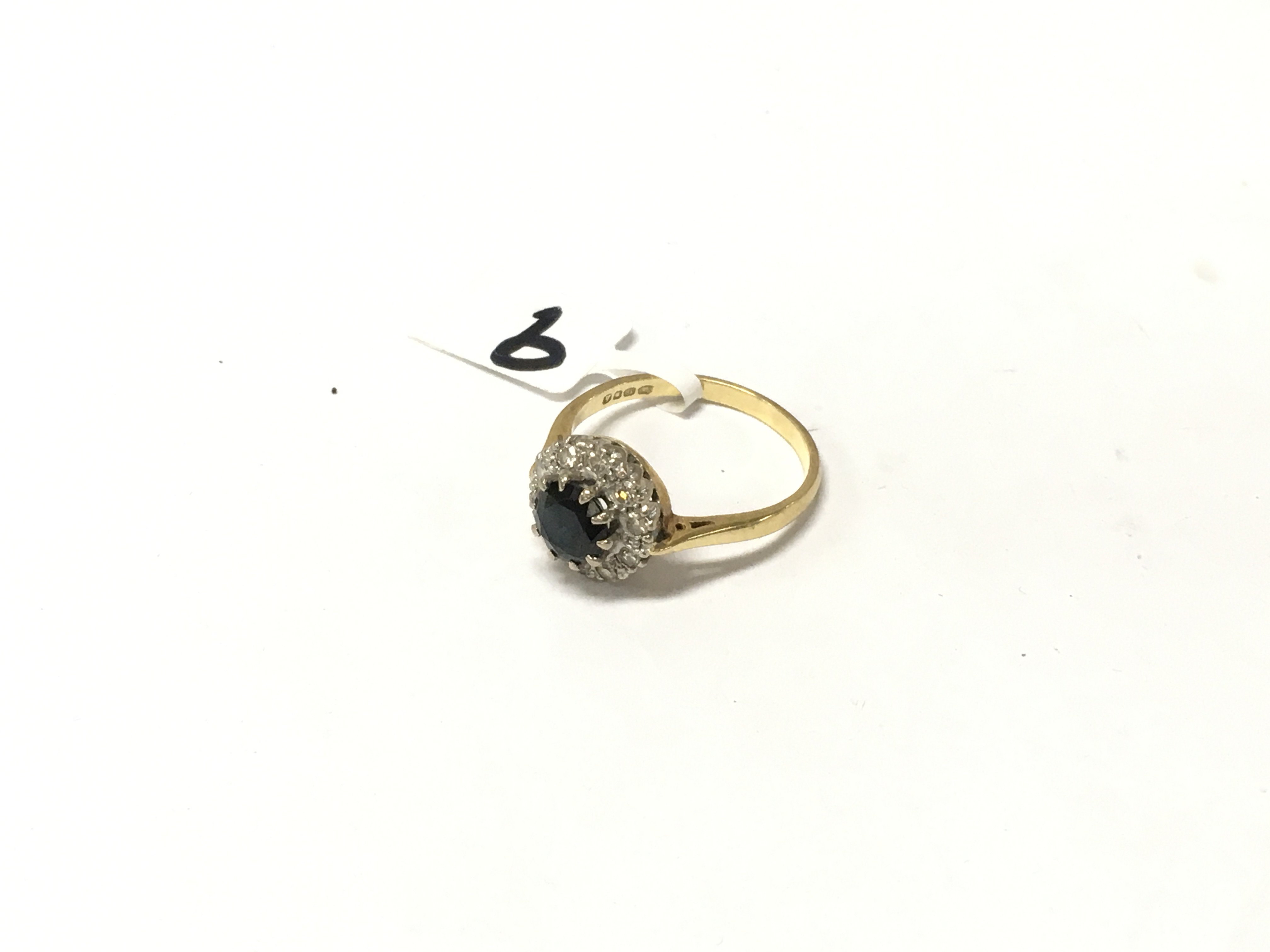 An 18ct gold diamond and sapphire ring. Size P 1/2, Approx weight 3.84 grams.