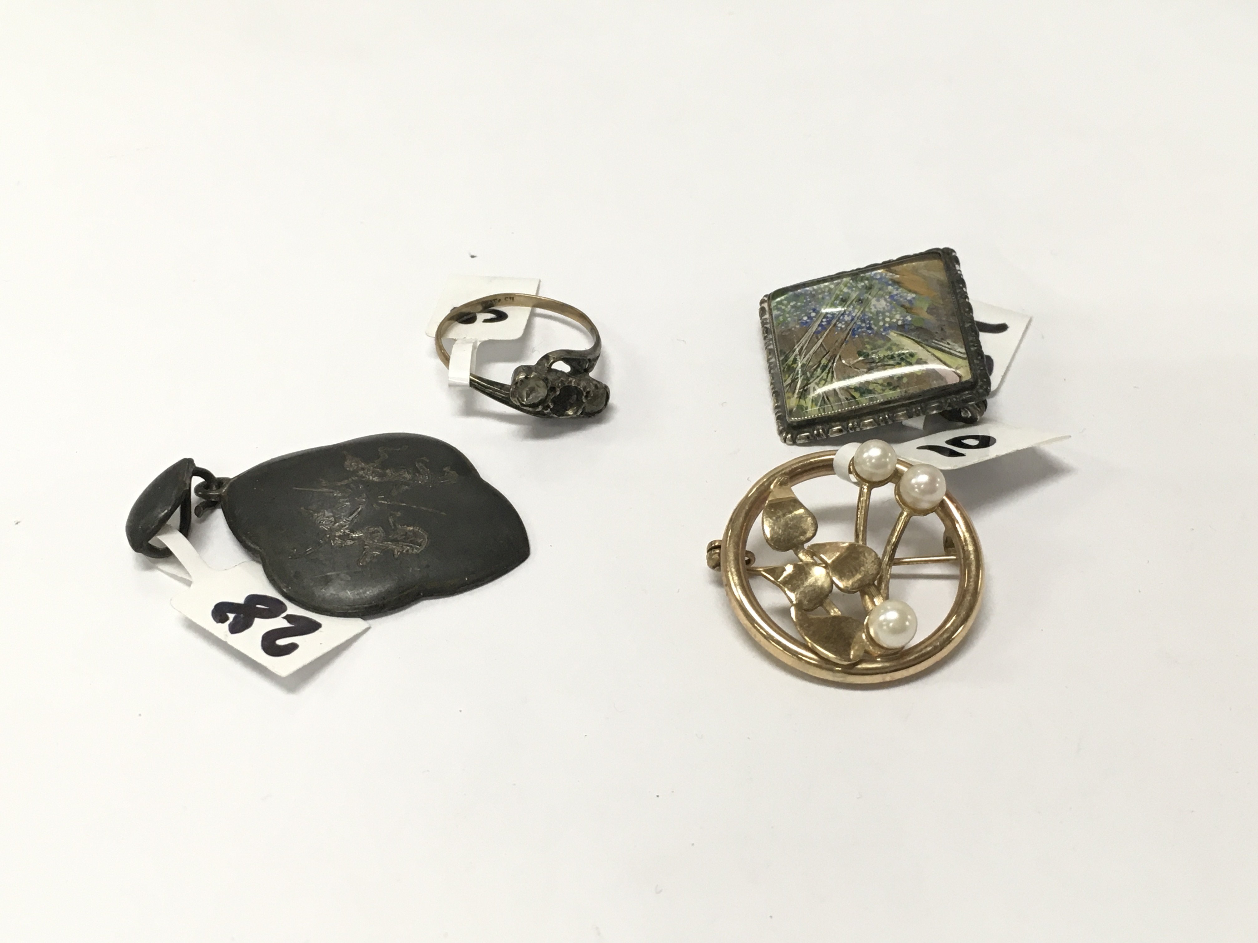 Two brooches and a silver ring and pendant.