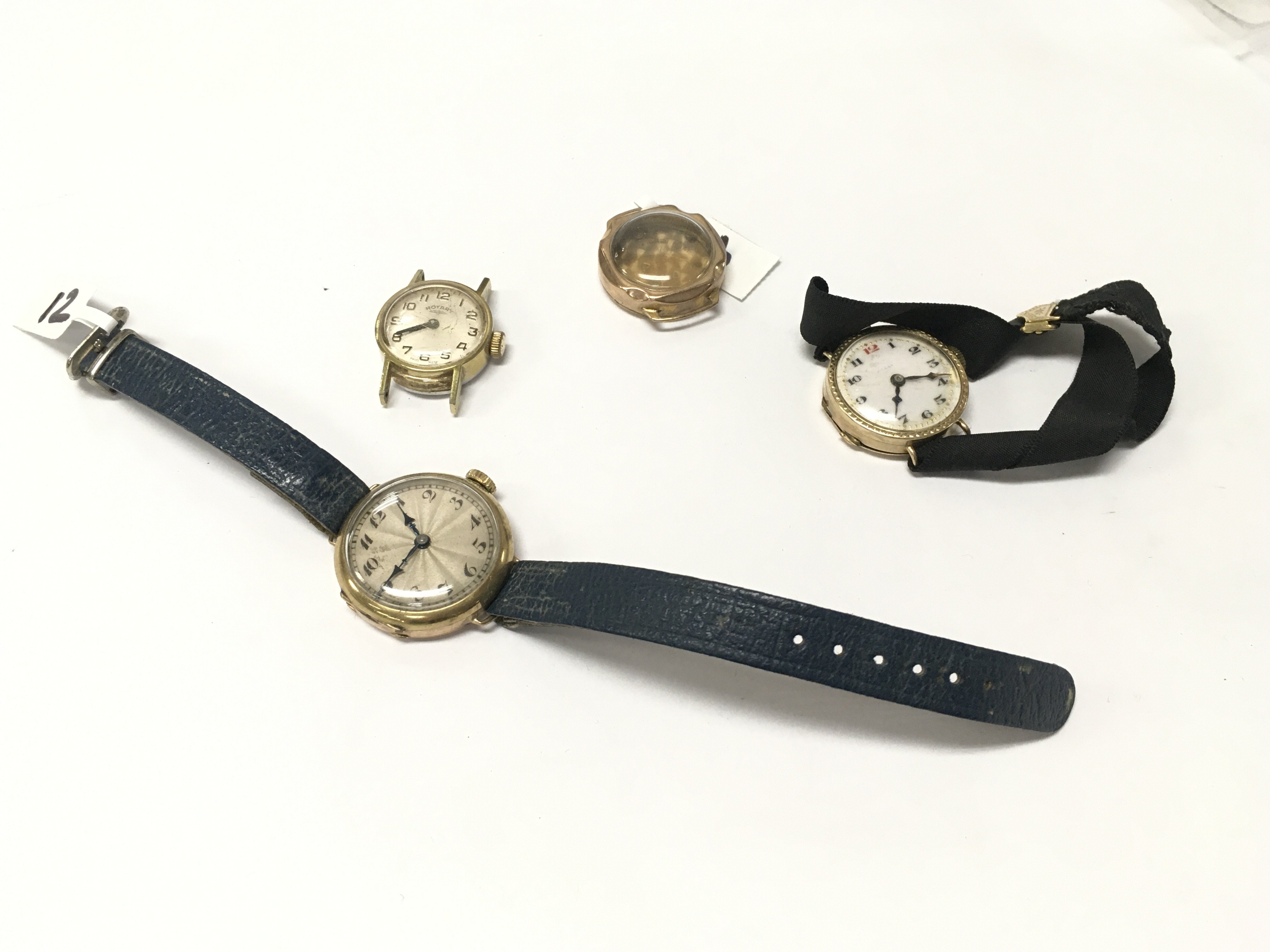 Three 9ct watch cases and one rotary cased movement.