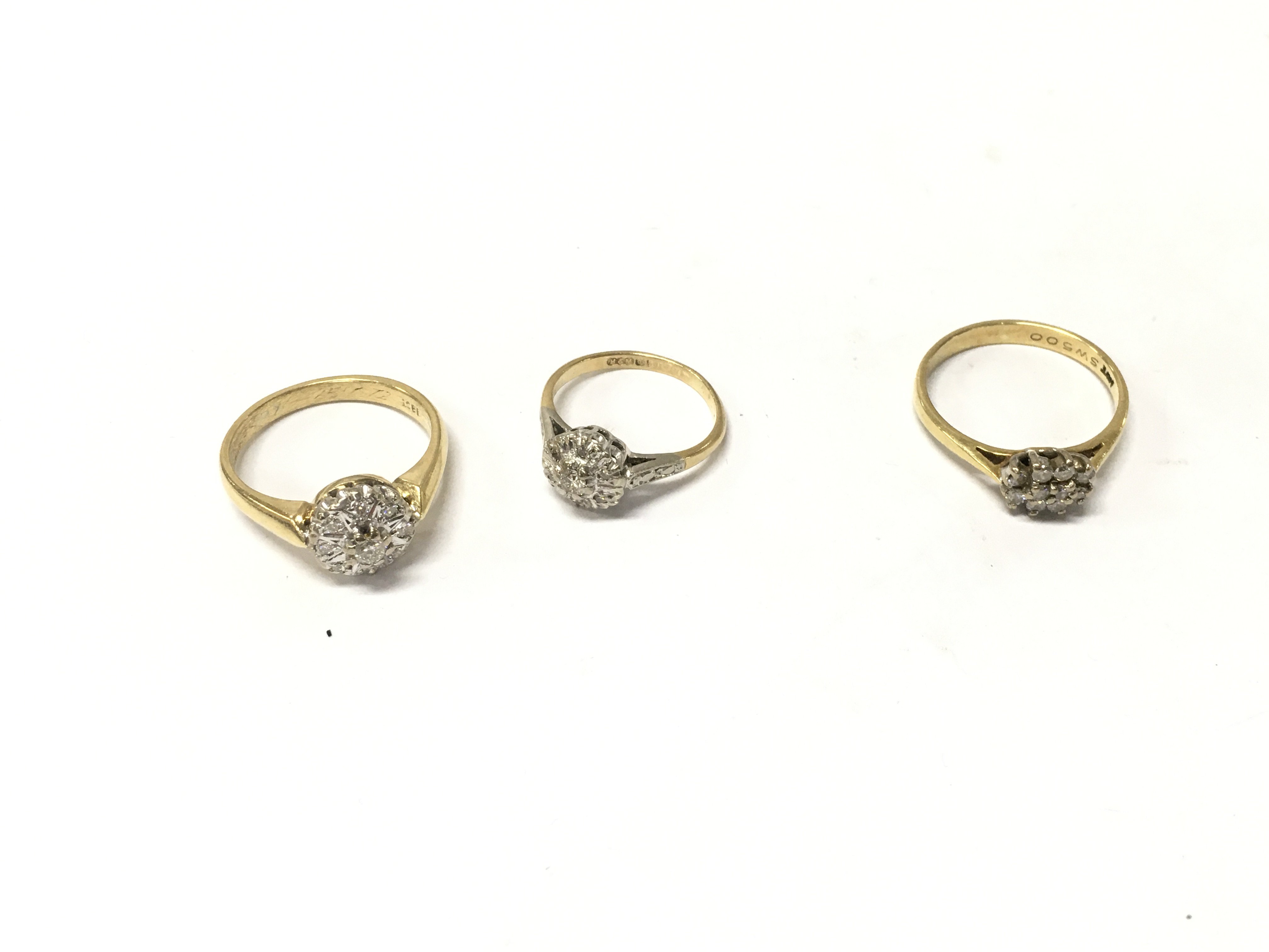 Three 18ct gold diamond cluster rings, sizes H,M,N. Approx weight 9.3grams.