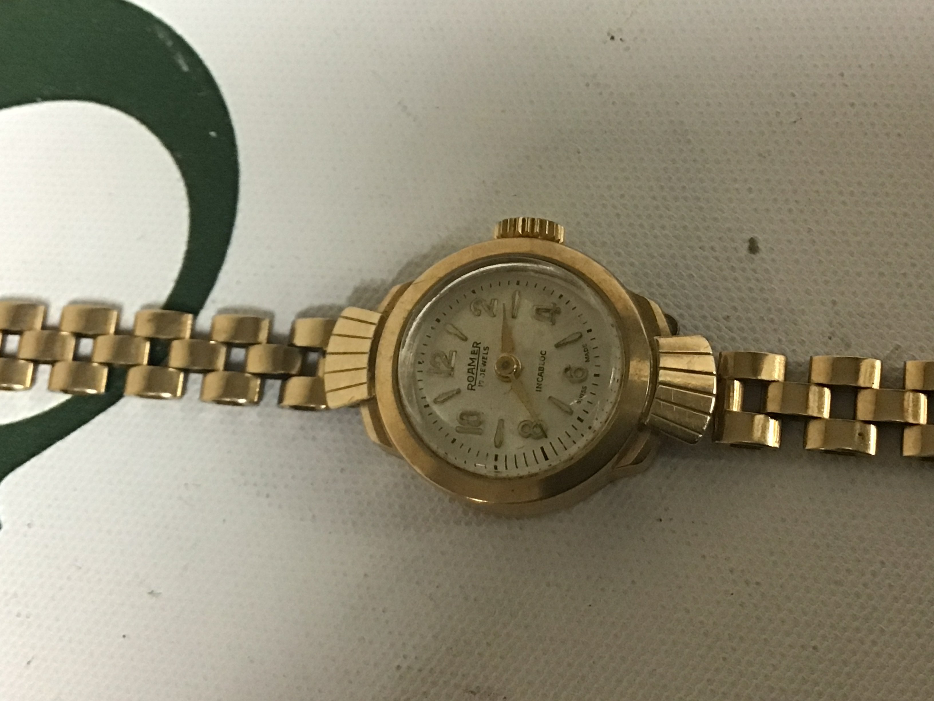 A Ladies 9carat gold cased Romar watch with attached gold bracelet weight 13.5g