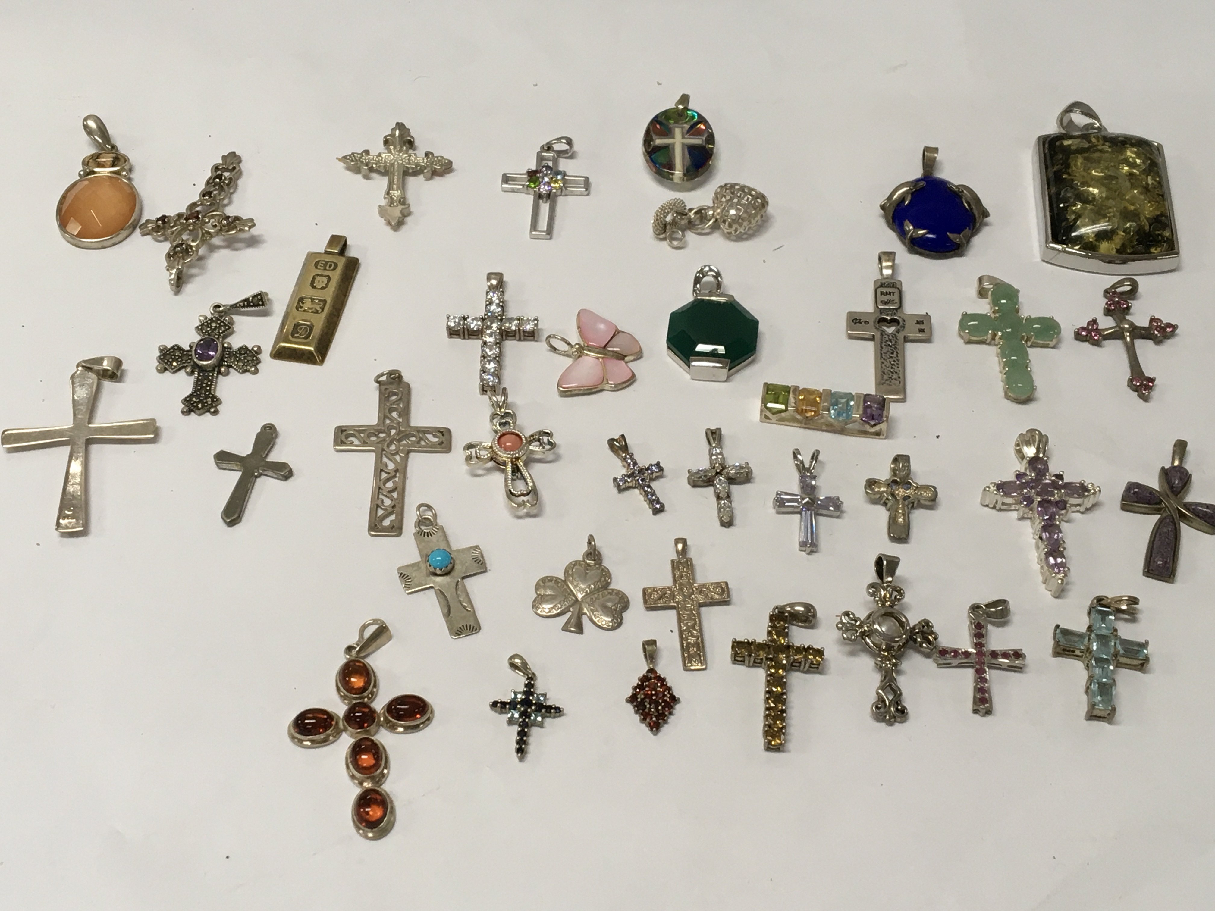A collection of silver cross pendants .