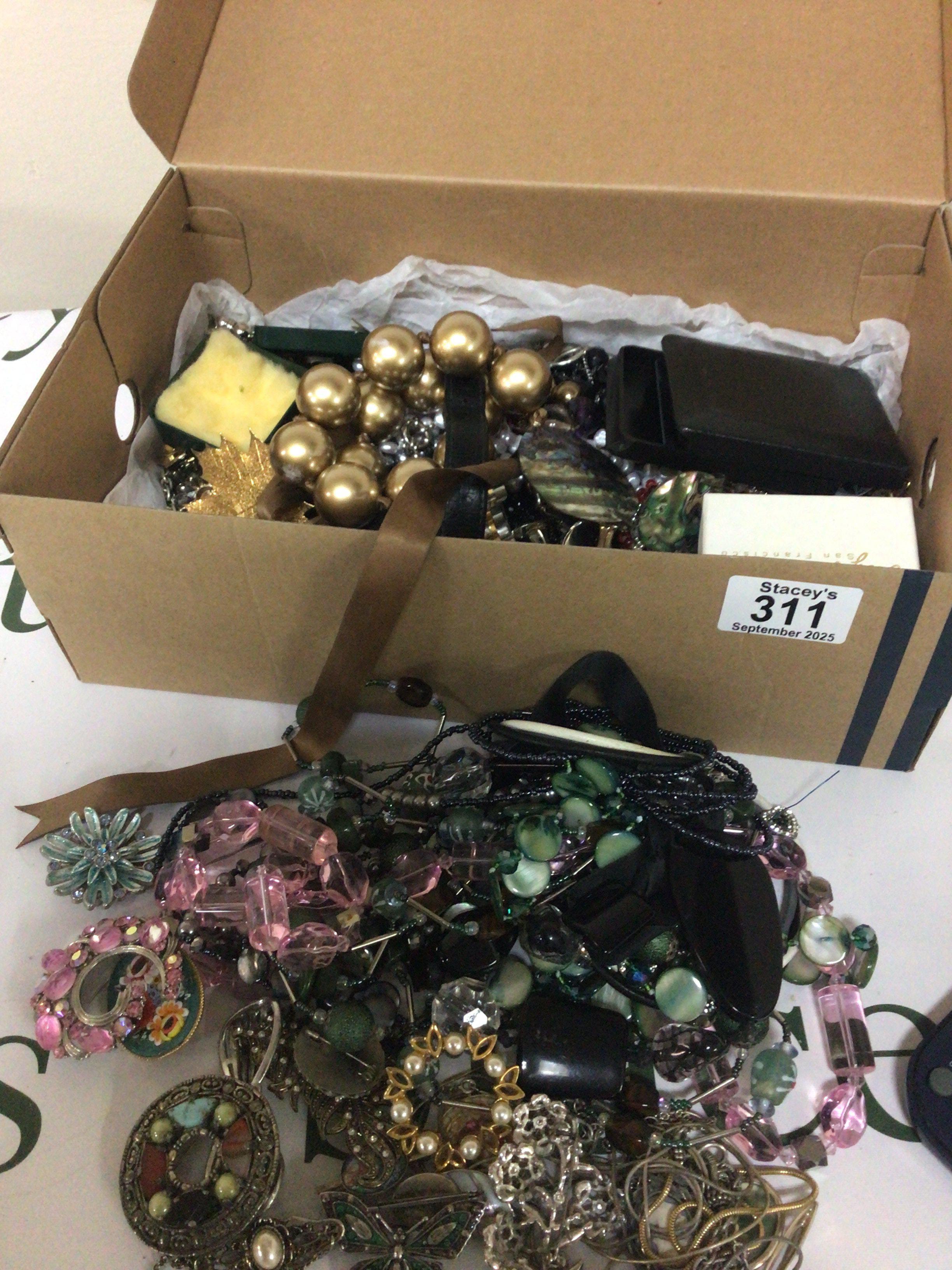 A box containing costume jewellery necklaces brooches watches.