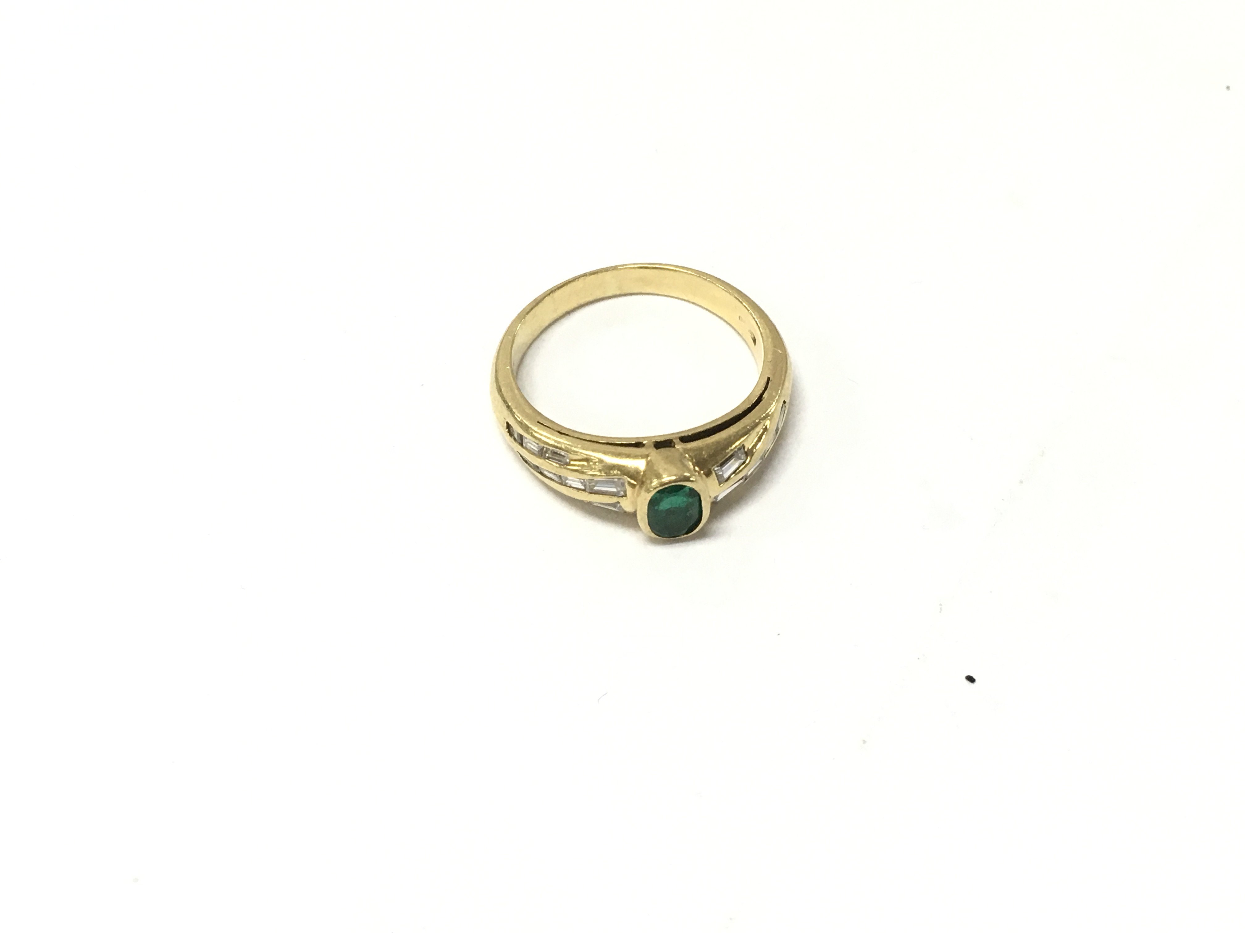 An 18ct gold emerald and diamond set ring. Size L, Approx weight 4.3grams.