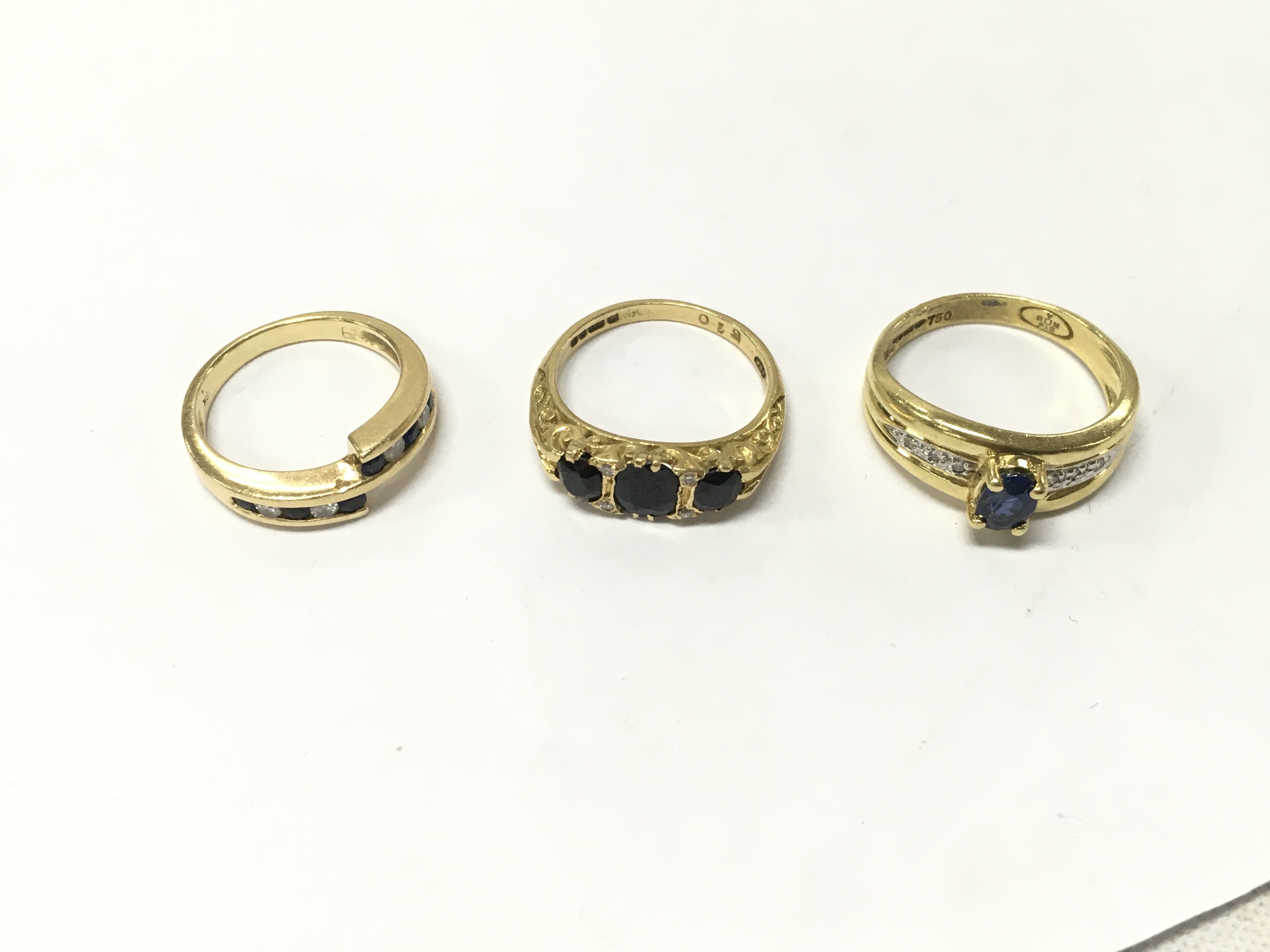 Three 18ct gold diamond and sapphire set rings.