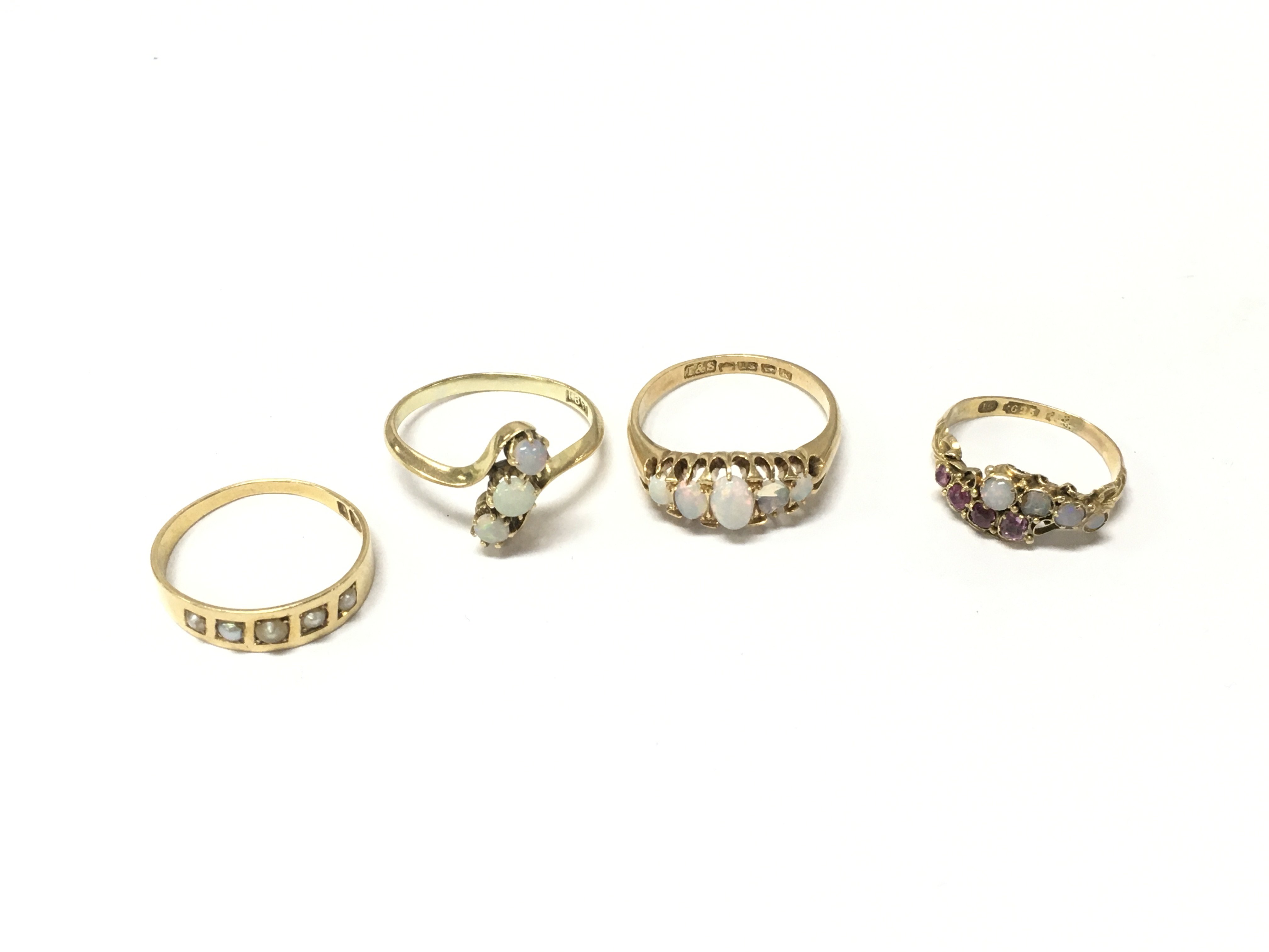 Three 18ct gold rings and one 15ct gold ring set with opals and pearls. Approx weight 10 grams, sizes I1/2,P,Q.