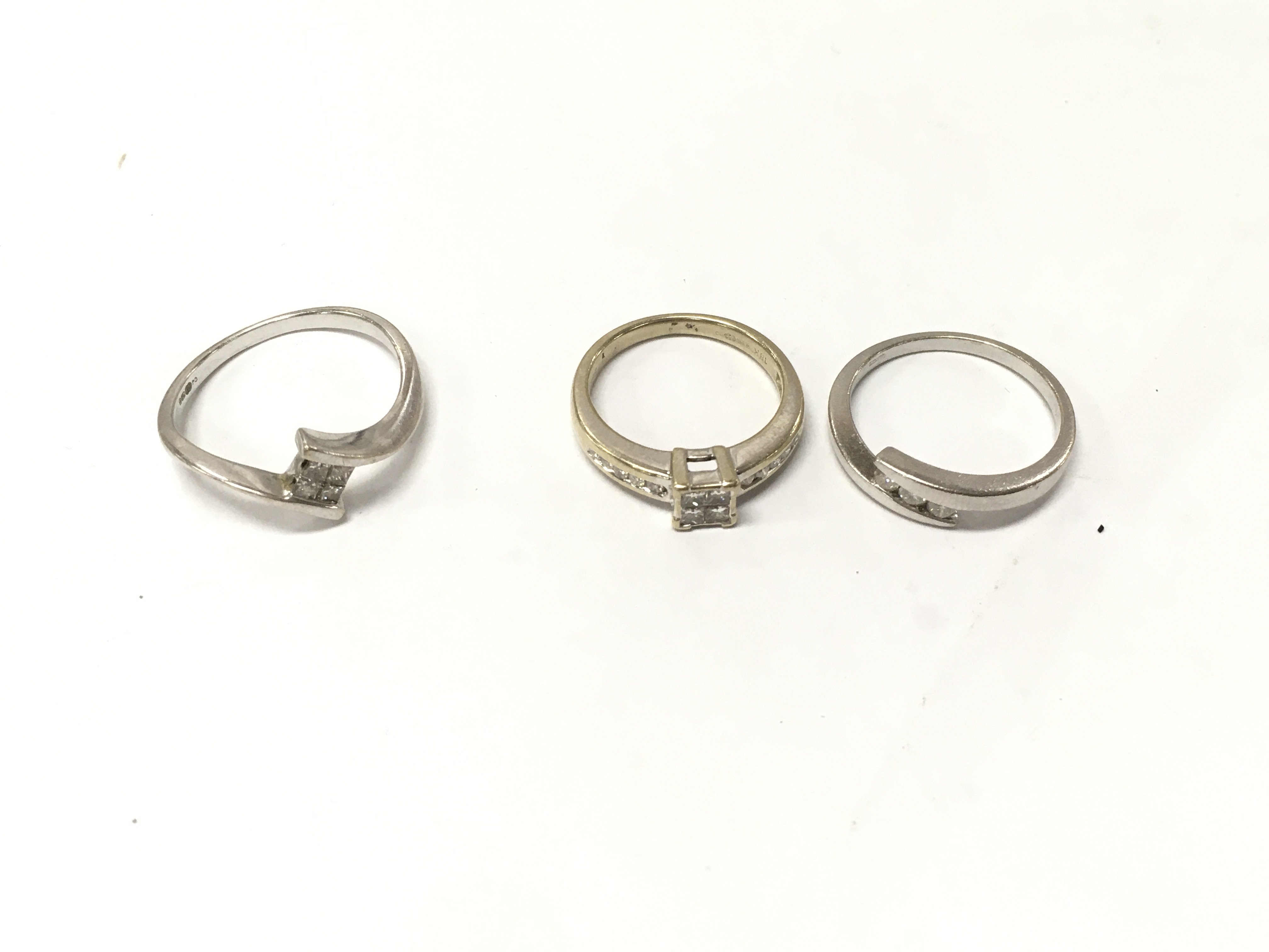 Three 18ct gold diamond set rings, sizes K,M,P1/2. Approx weight 8.6 grams.
