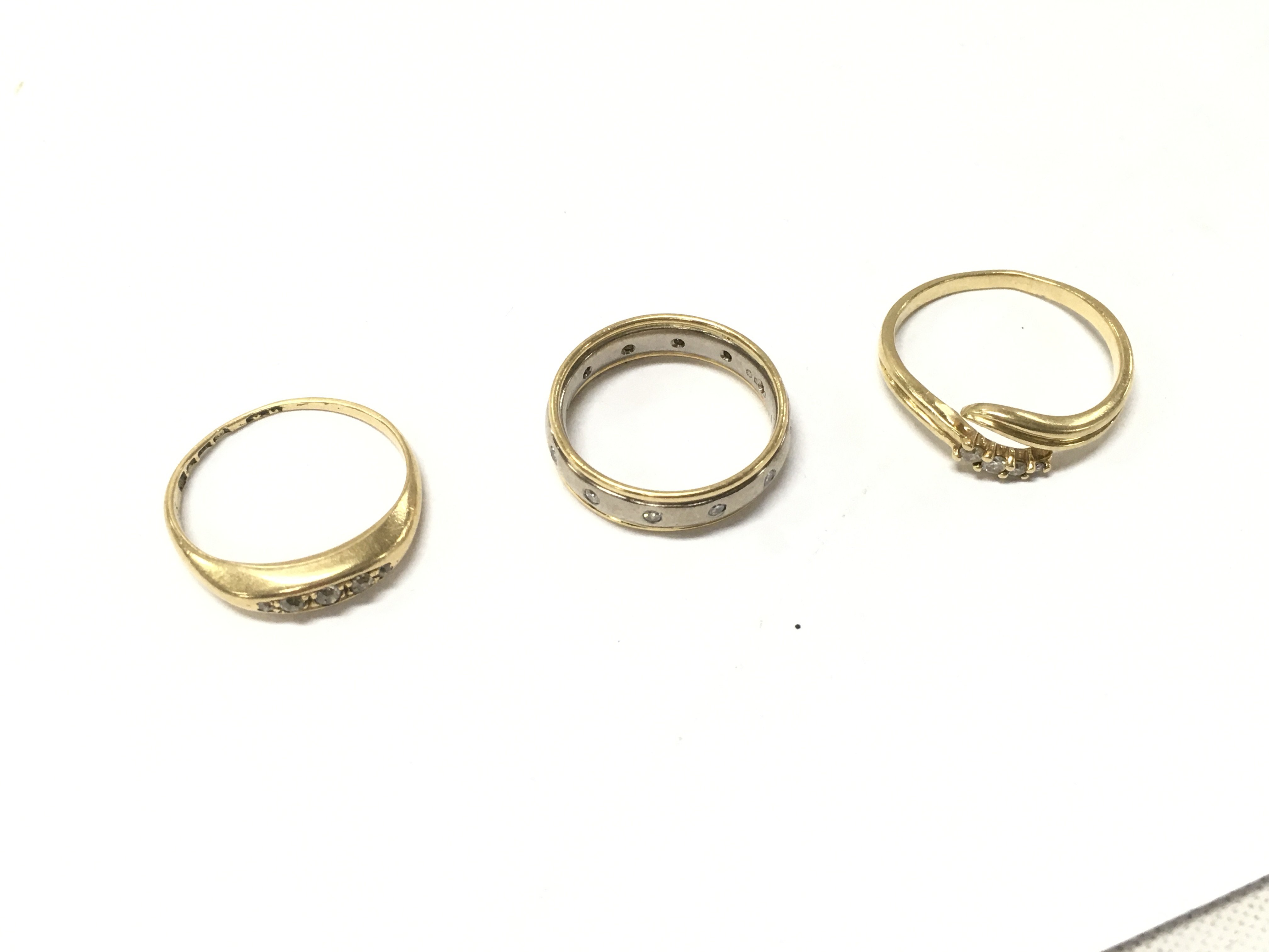 Three 18ct gold diamond rings, sizes I,K,O. Approx weight 8.8 grams.