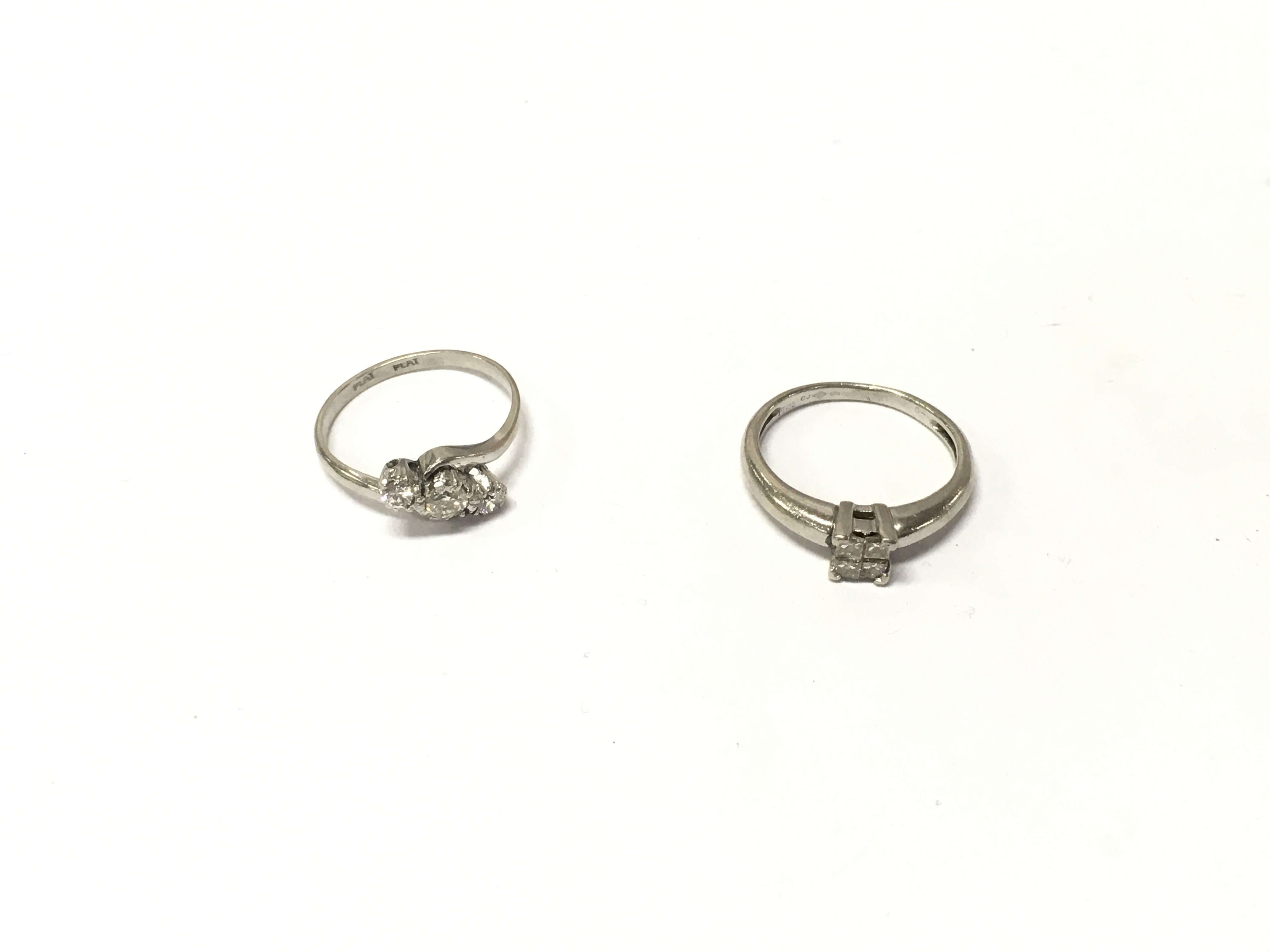 Two platinum diamond rings. Approx weight 6 grams, size K.