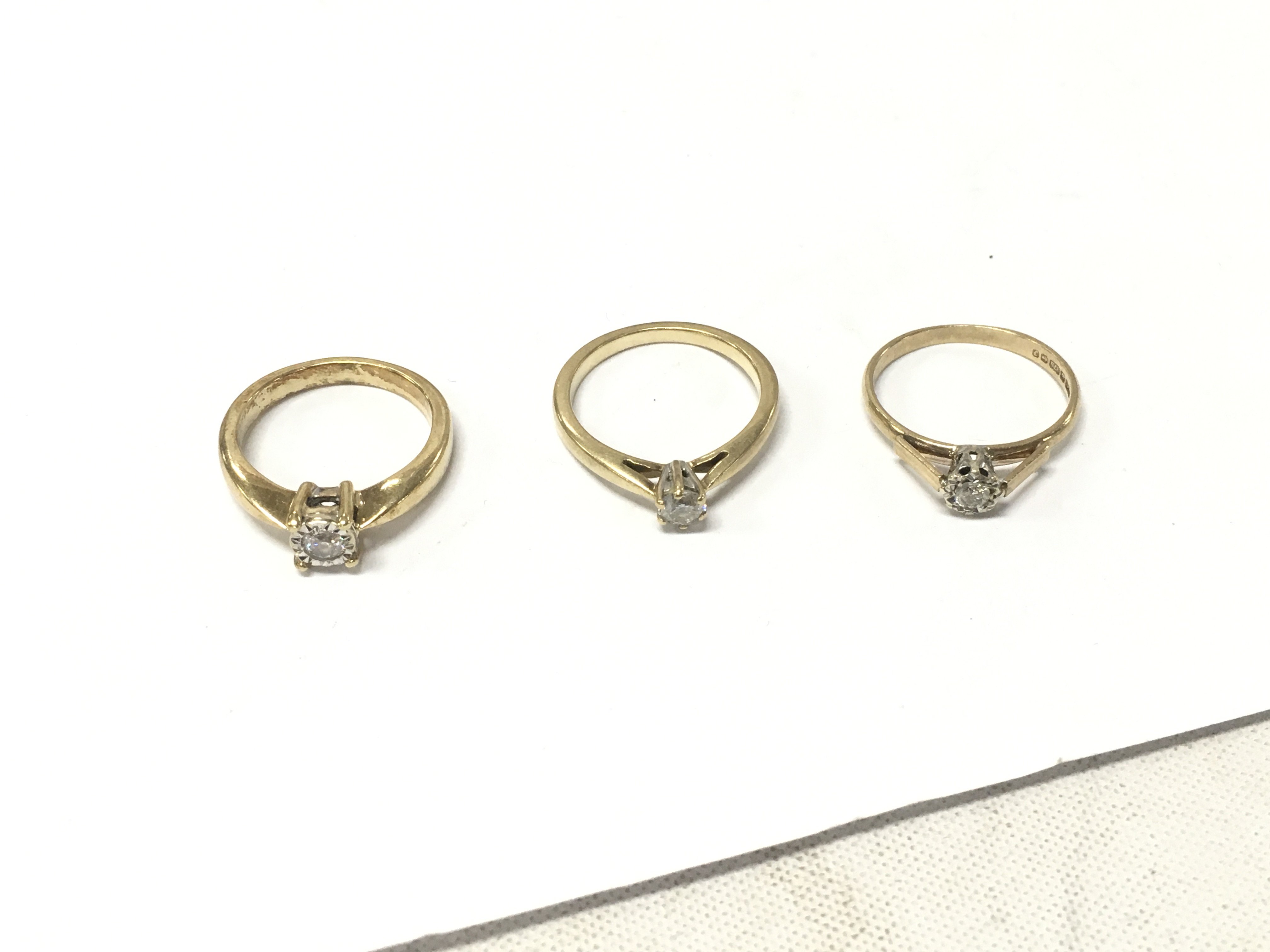 Three 9ct gold diamond solitaire rings. Size L,M, Approx weight 7.8 grams