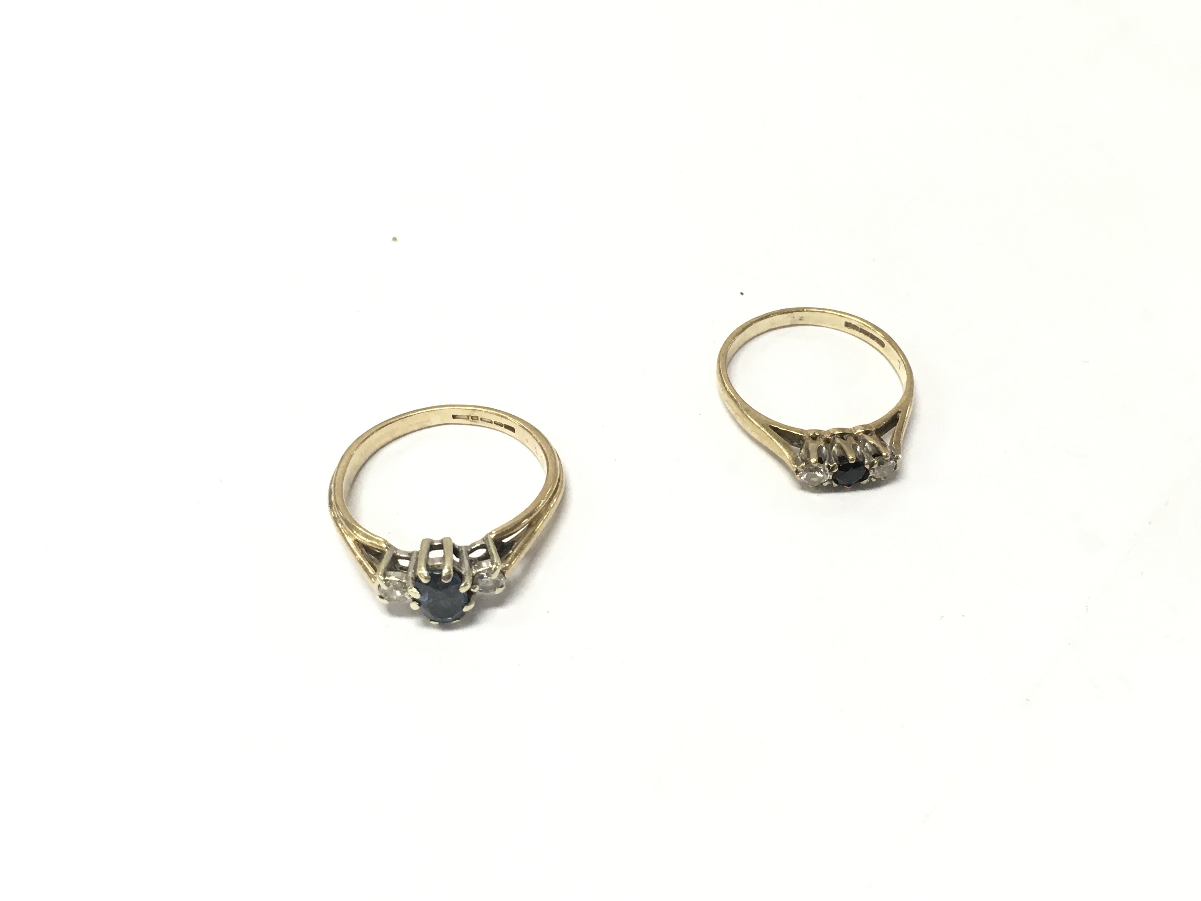 Two 9ct gold diamond and sapphire three stone rings, size K,N. Approx weight 3.8 grams.