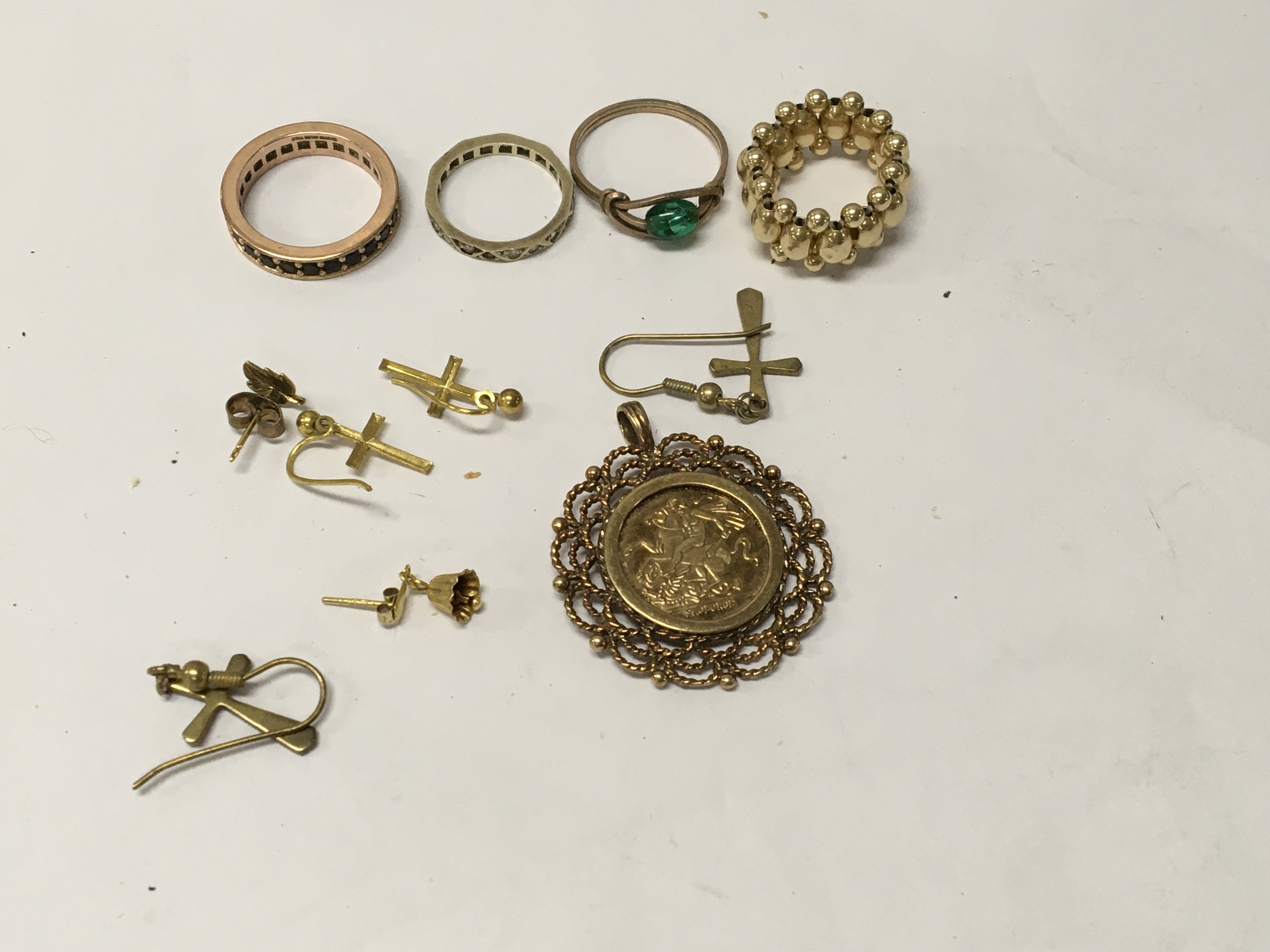 A 14 ct gold expanded ring together with three other rings earrings and pendant.