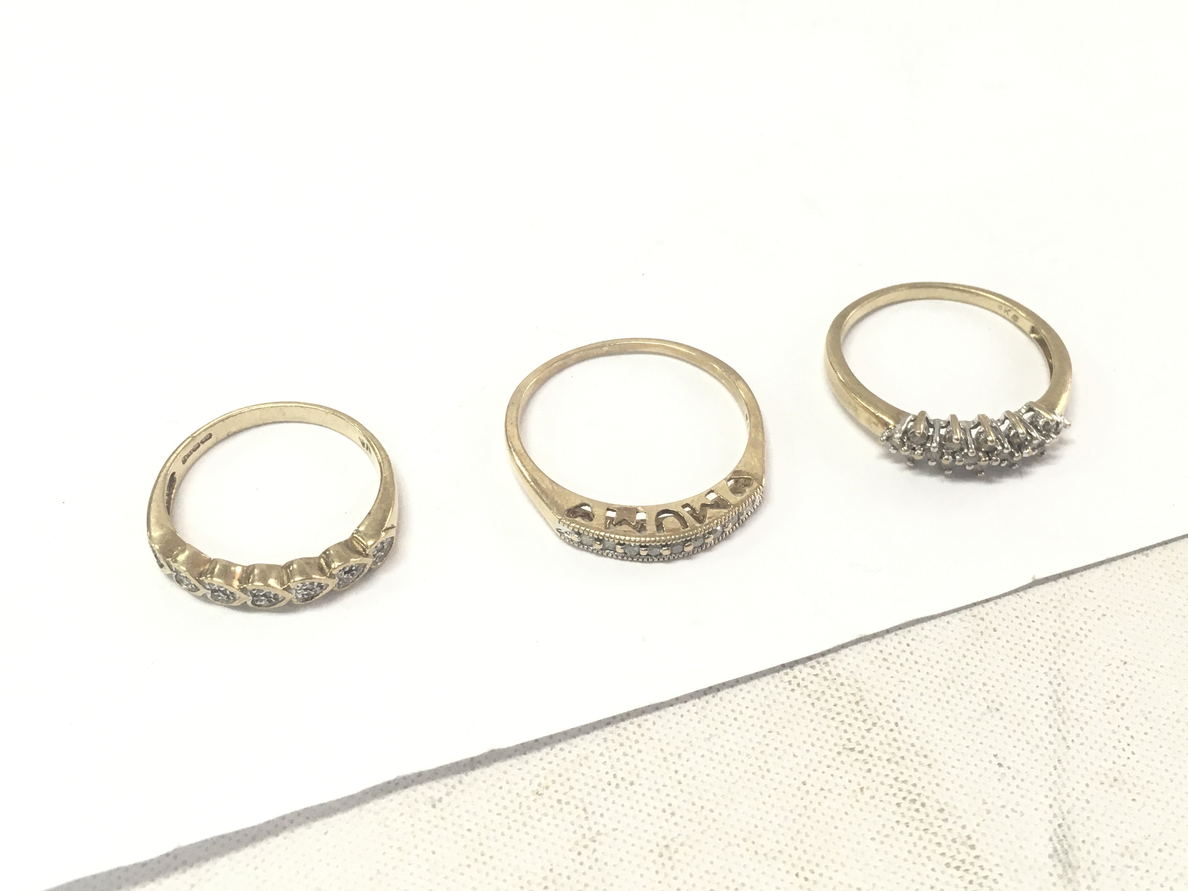 Three 9ct gold diamond set rings, size O1/2,R1/2,V. Approx weight 7.1 grams.