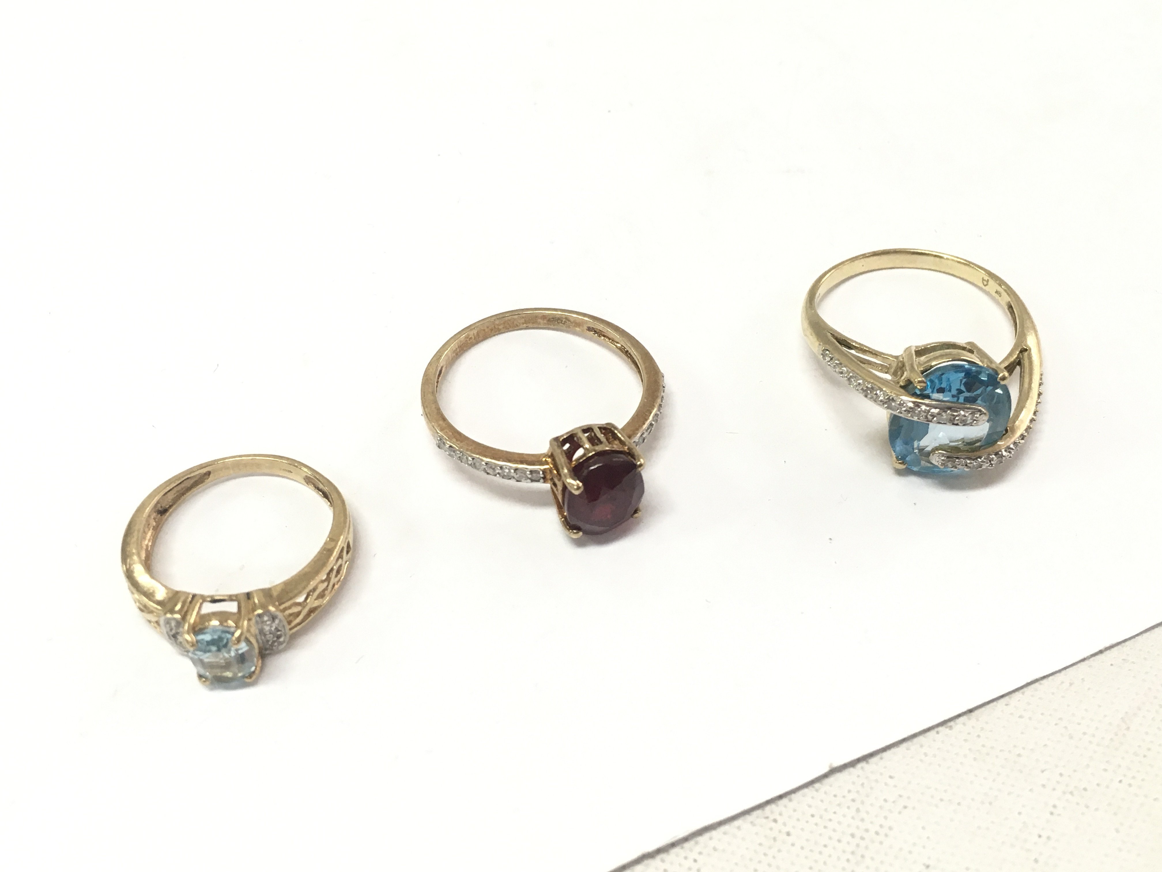 Three mixed stone 9ct gold rings. Approx weight 9.5 grams size J,R.