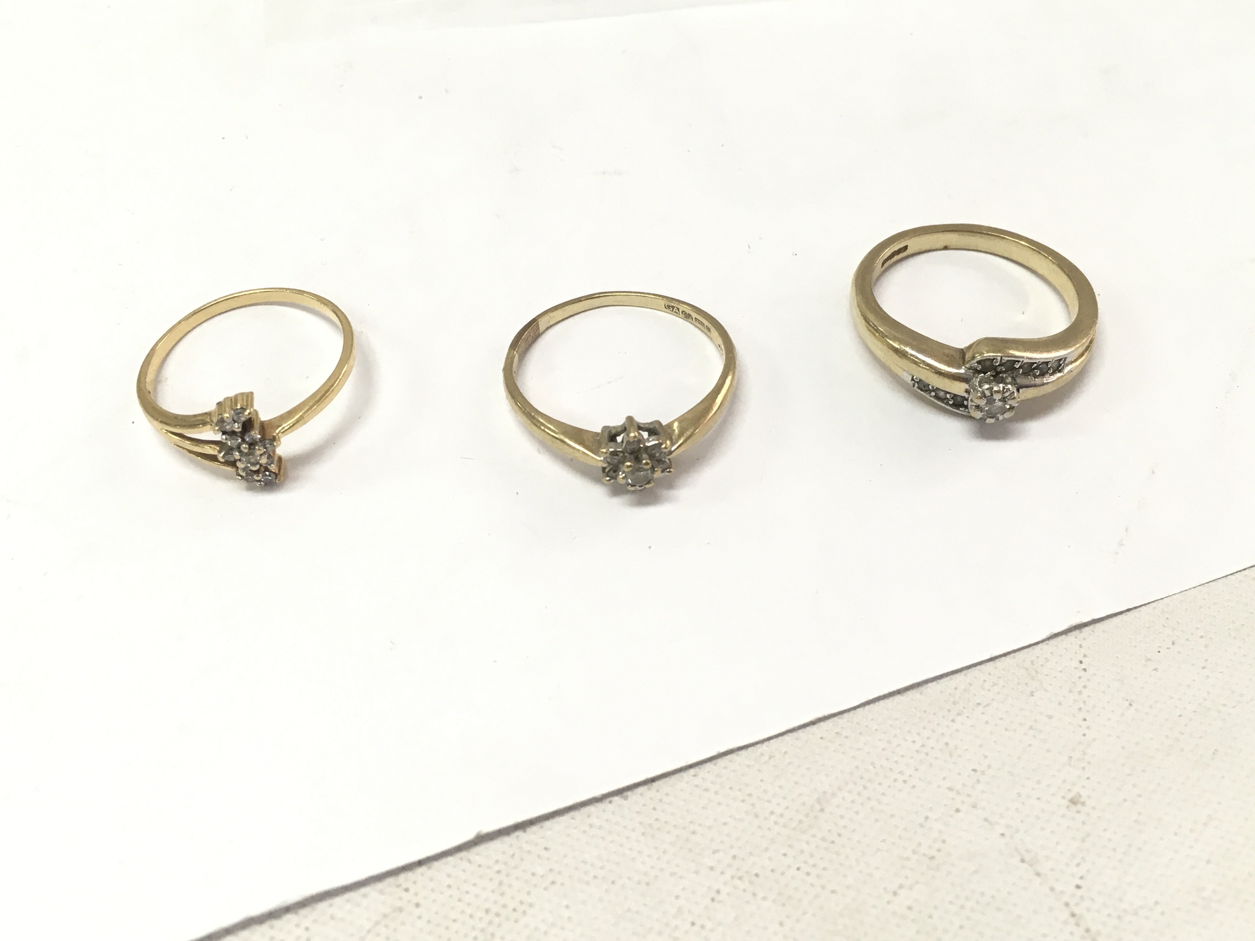 Three 9ct gold cluster rings Approx weight 6.9 grams. Size M,P.