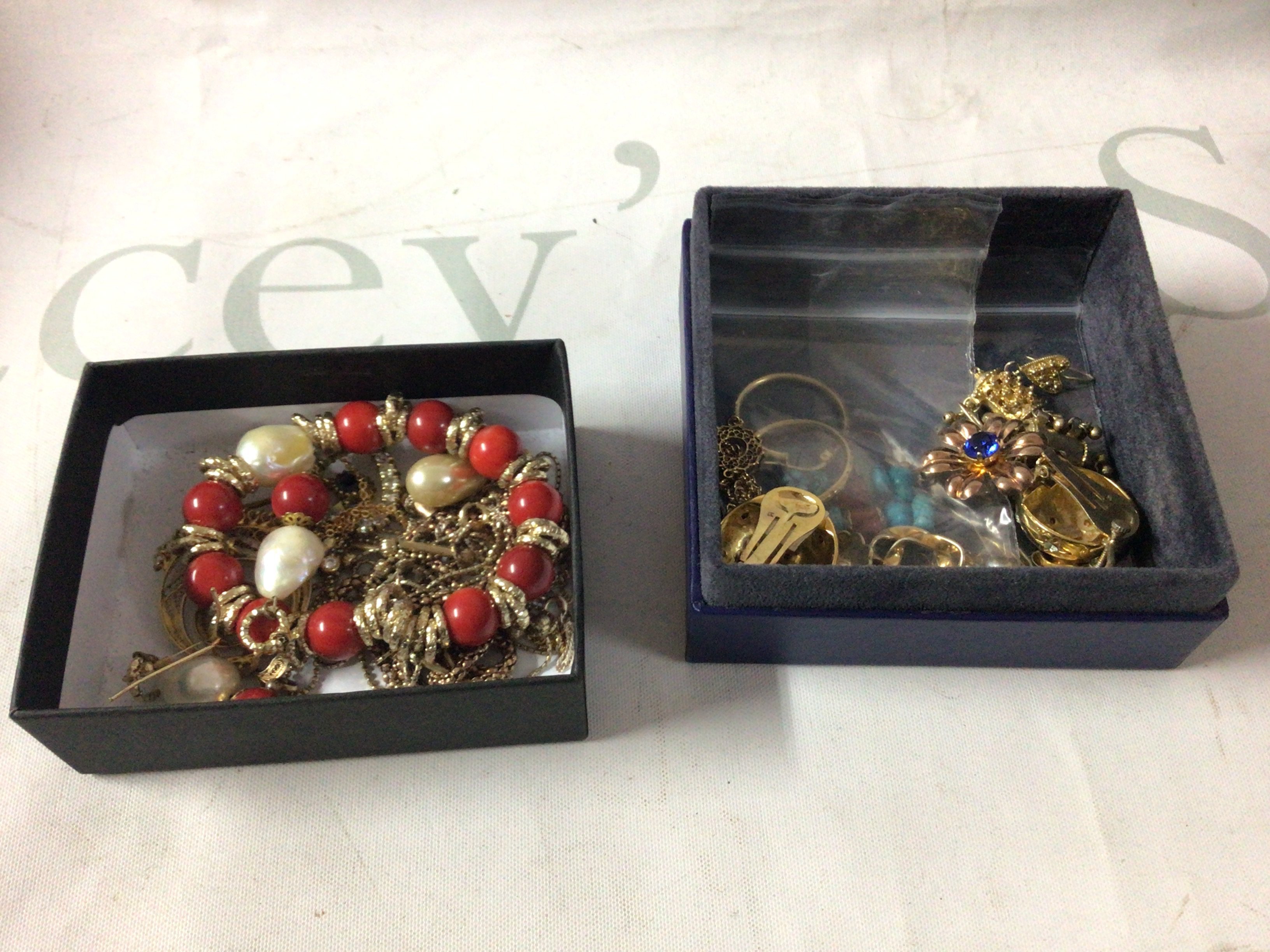 A small collection of silver and silver gilded jewellery, including a coral and pearl bracelet and earring set and other eastern style pendants.