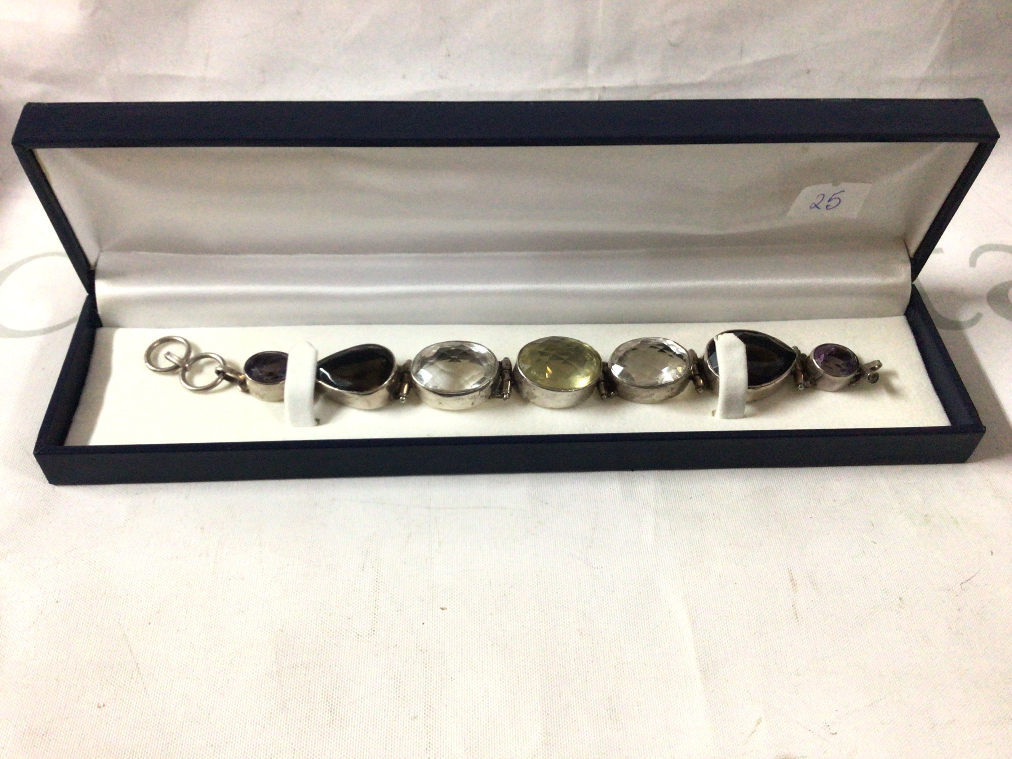 A Silver stone set bracelet, set with quartz stones, amethyst and citrines.