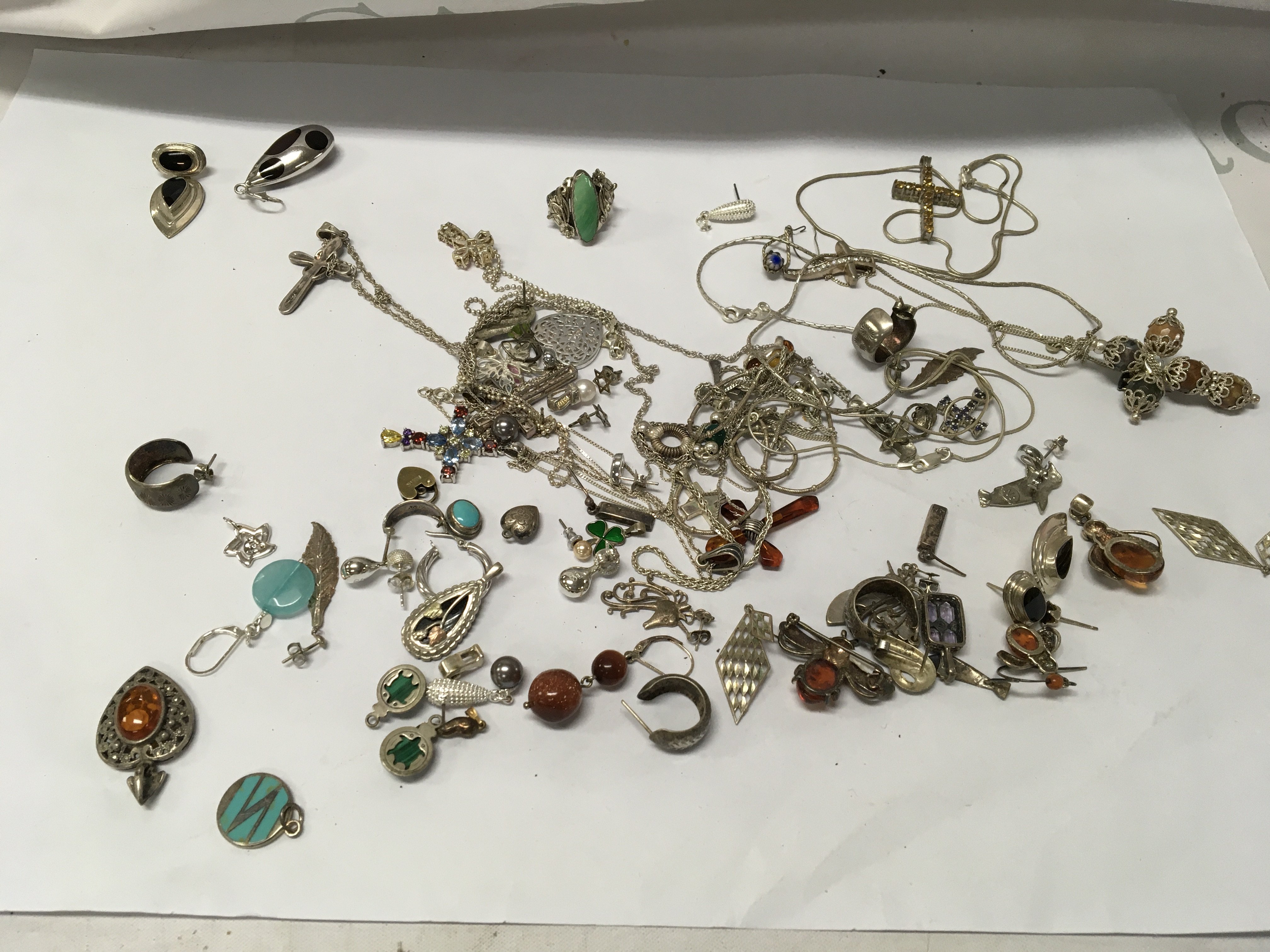 A collection of silver pendants and chains .