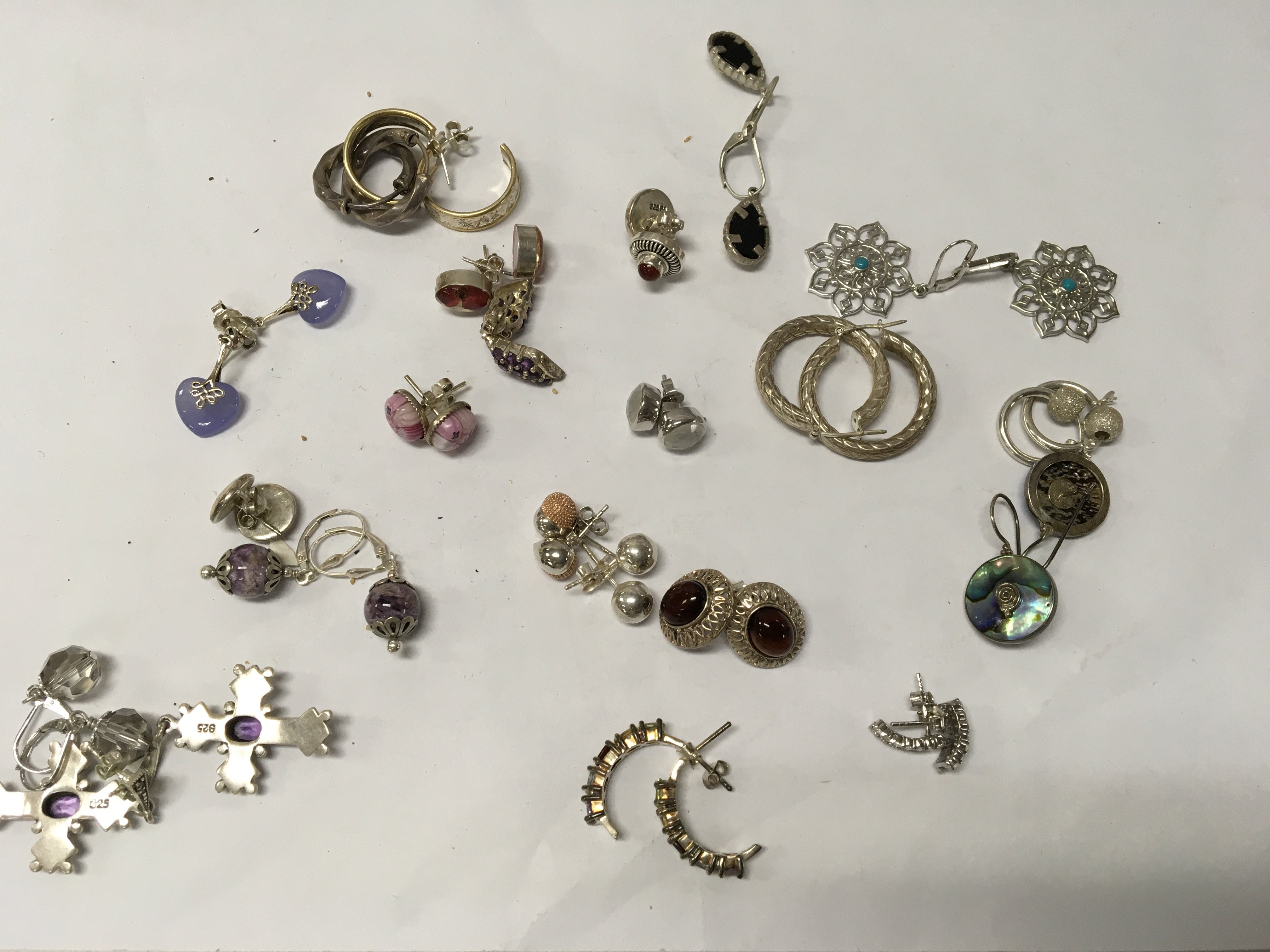 A collection of silver earrings.