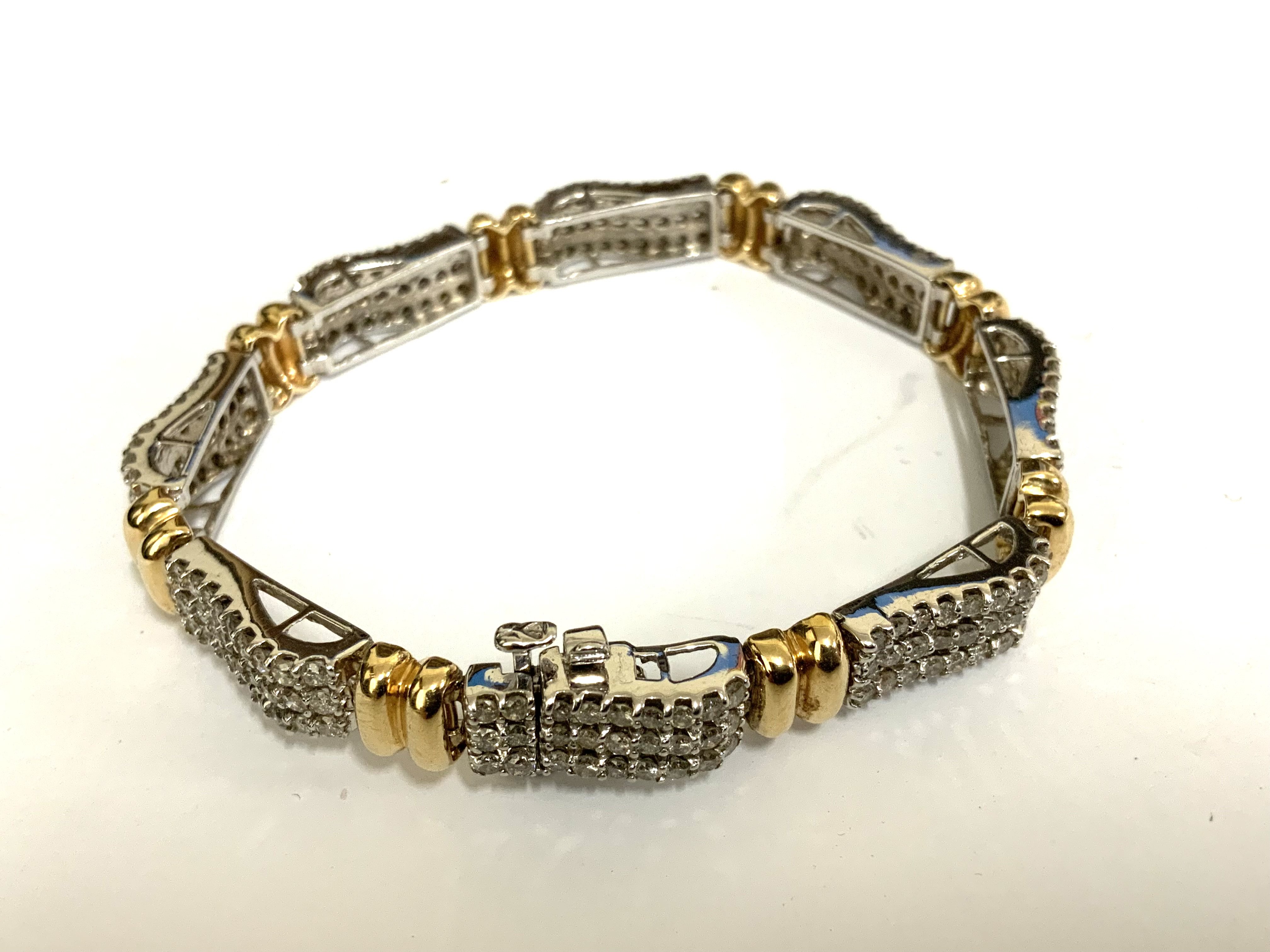 A good quality 14ct yellow and white gold bracelet made up of 8 sections each inset with 27, 0.01ct stones (total weight approximately 2.16ct). (A)