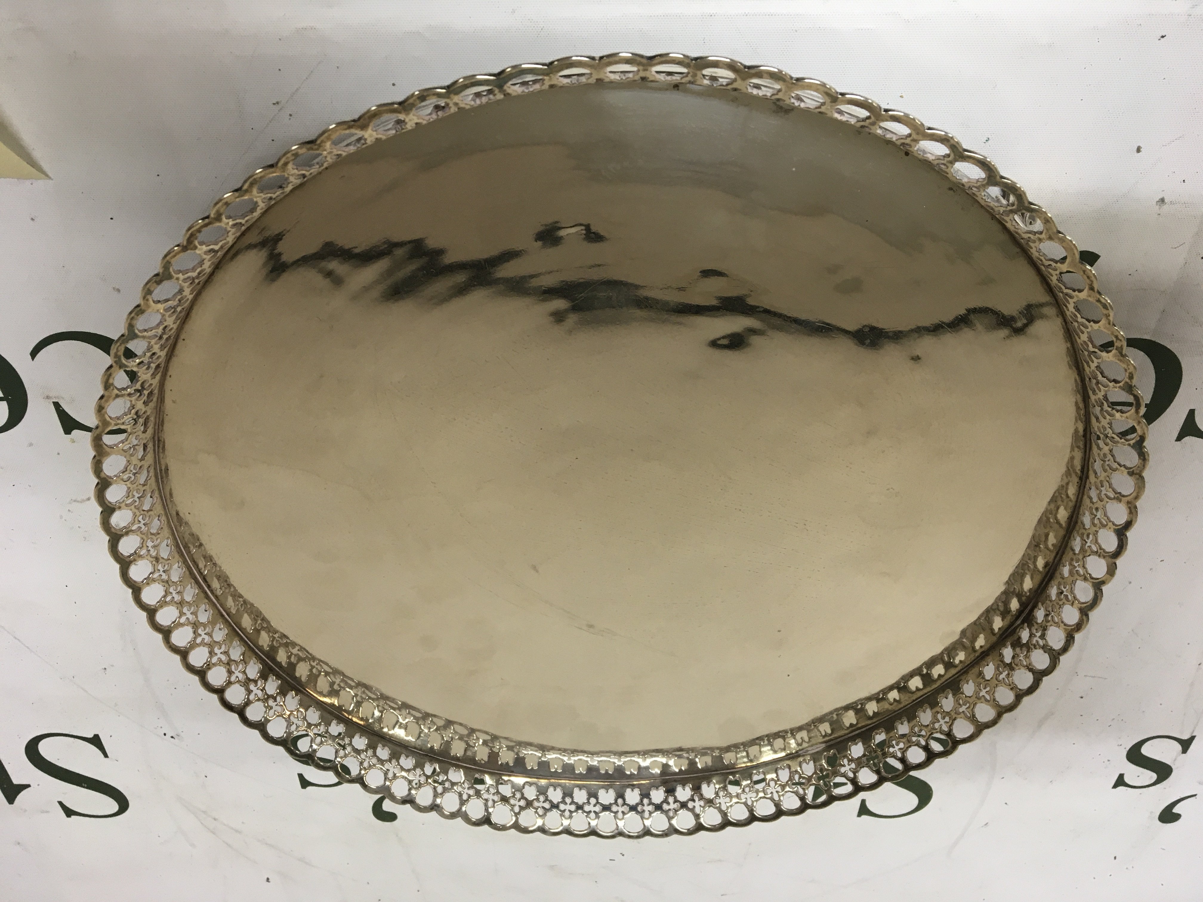 A Continental possible German white metal tray of circular shape with a pierced edge and feet. Marks to the reverse see image. 30cm diameter. 875g approximately.