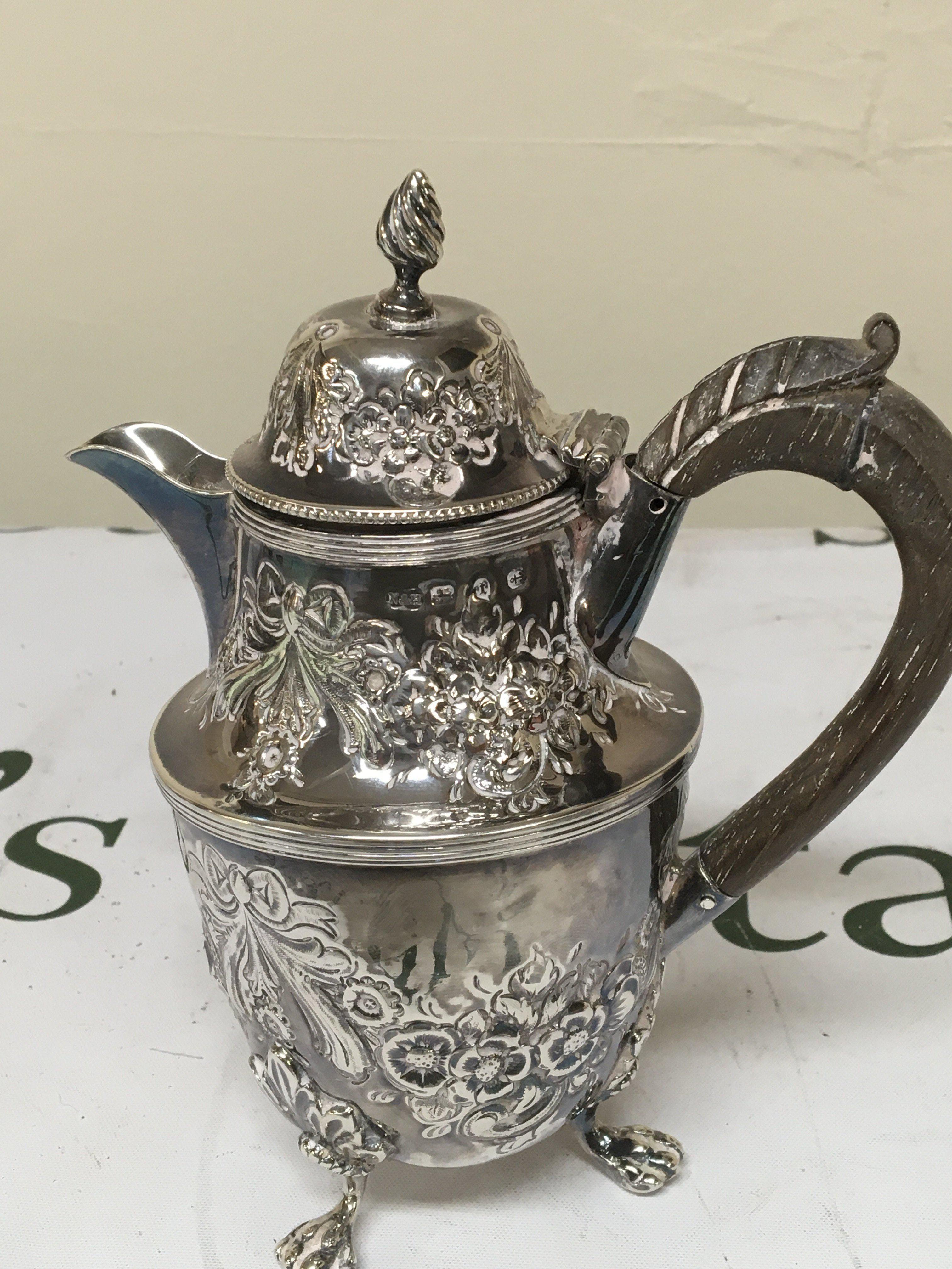 A small Victorian silver coffee or chocolate pot repousse chased with garlands simulated ribbon ties. Height 17cm weight 251g