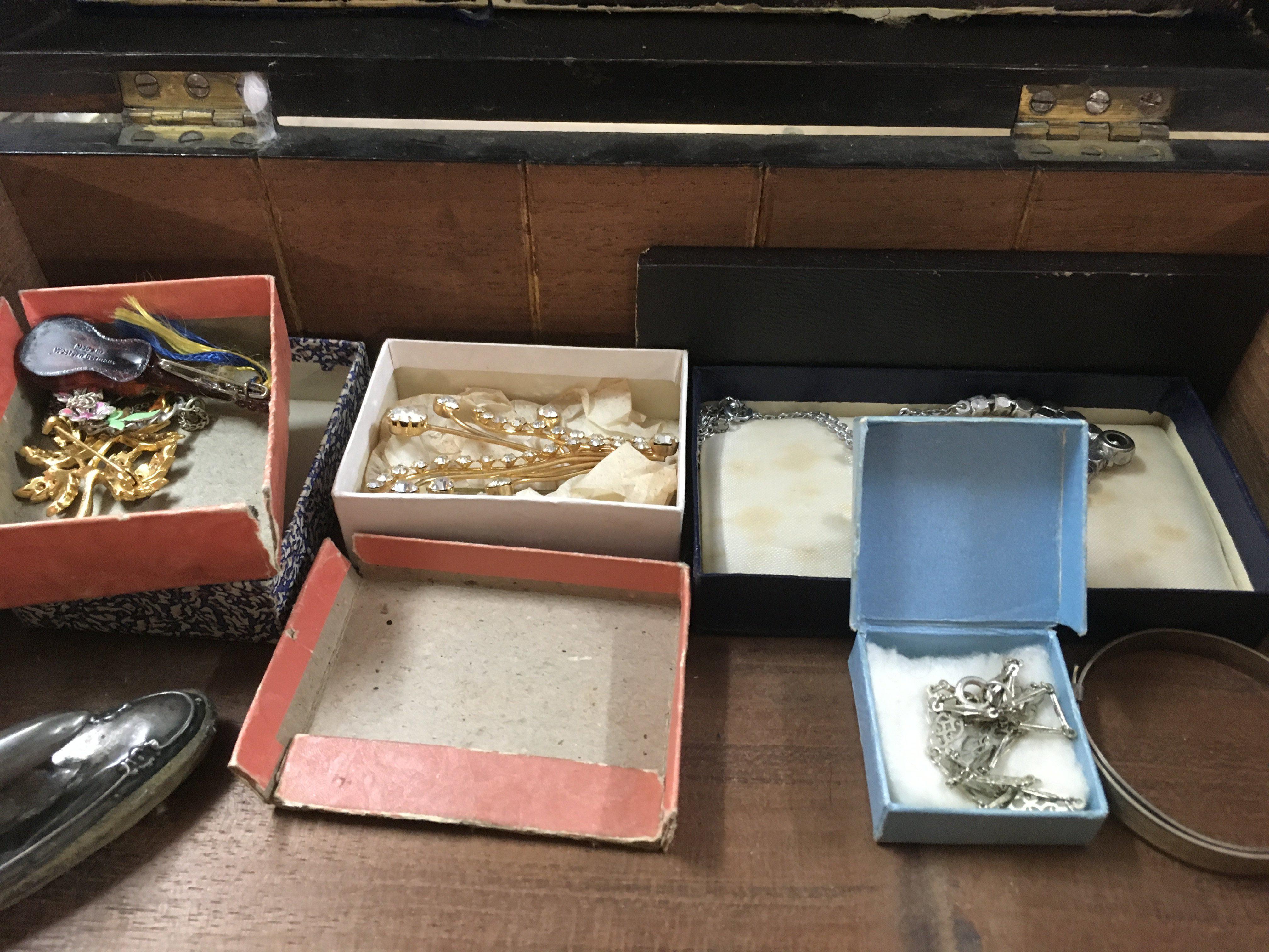 A mahogany box containing costume jewellery various.