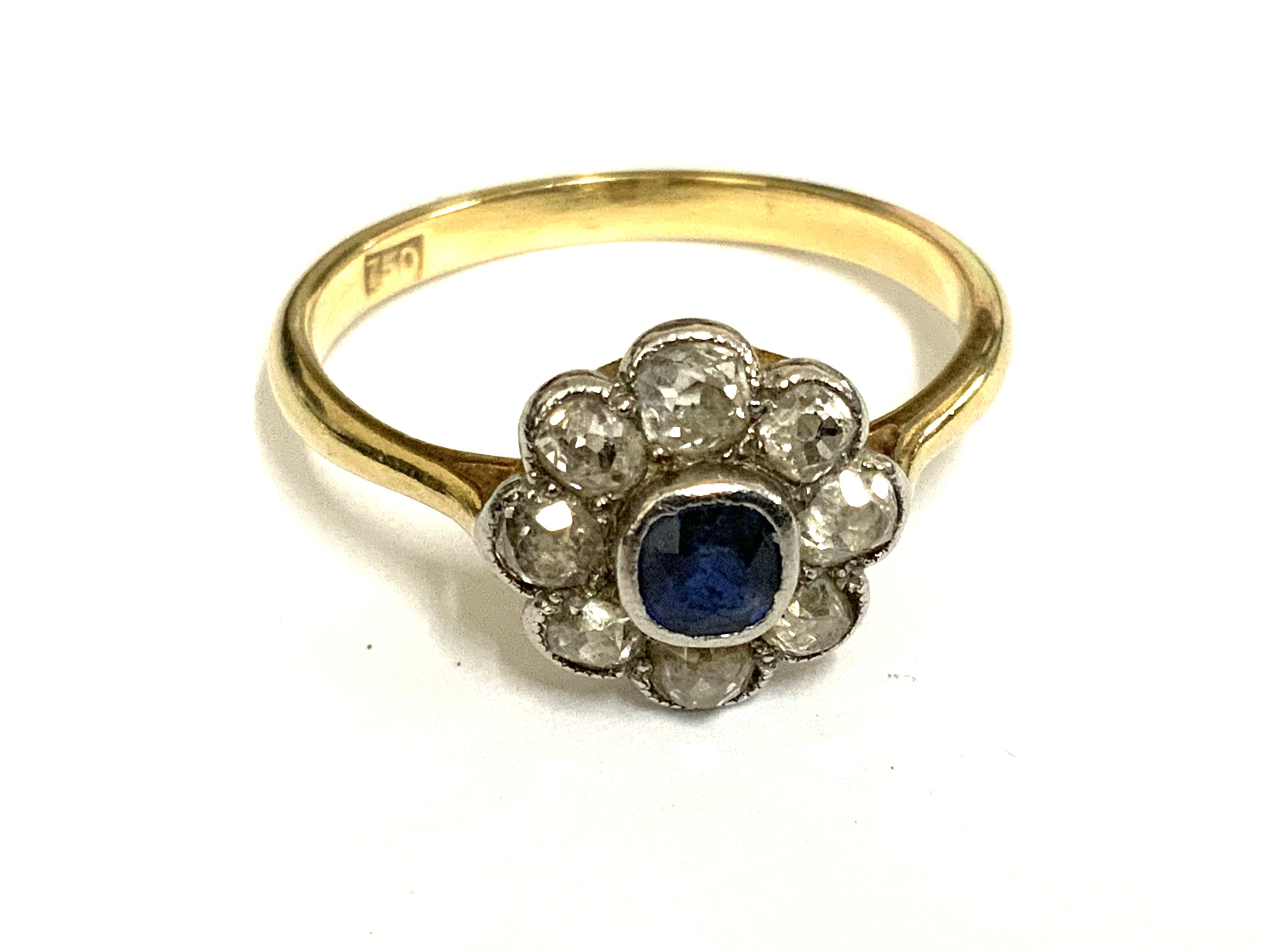 An 18ct gold sapphire and diamond daisy cluster ring, Size Q. (A)
