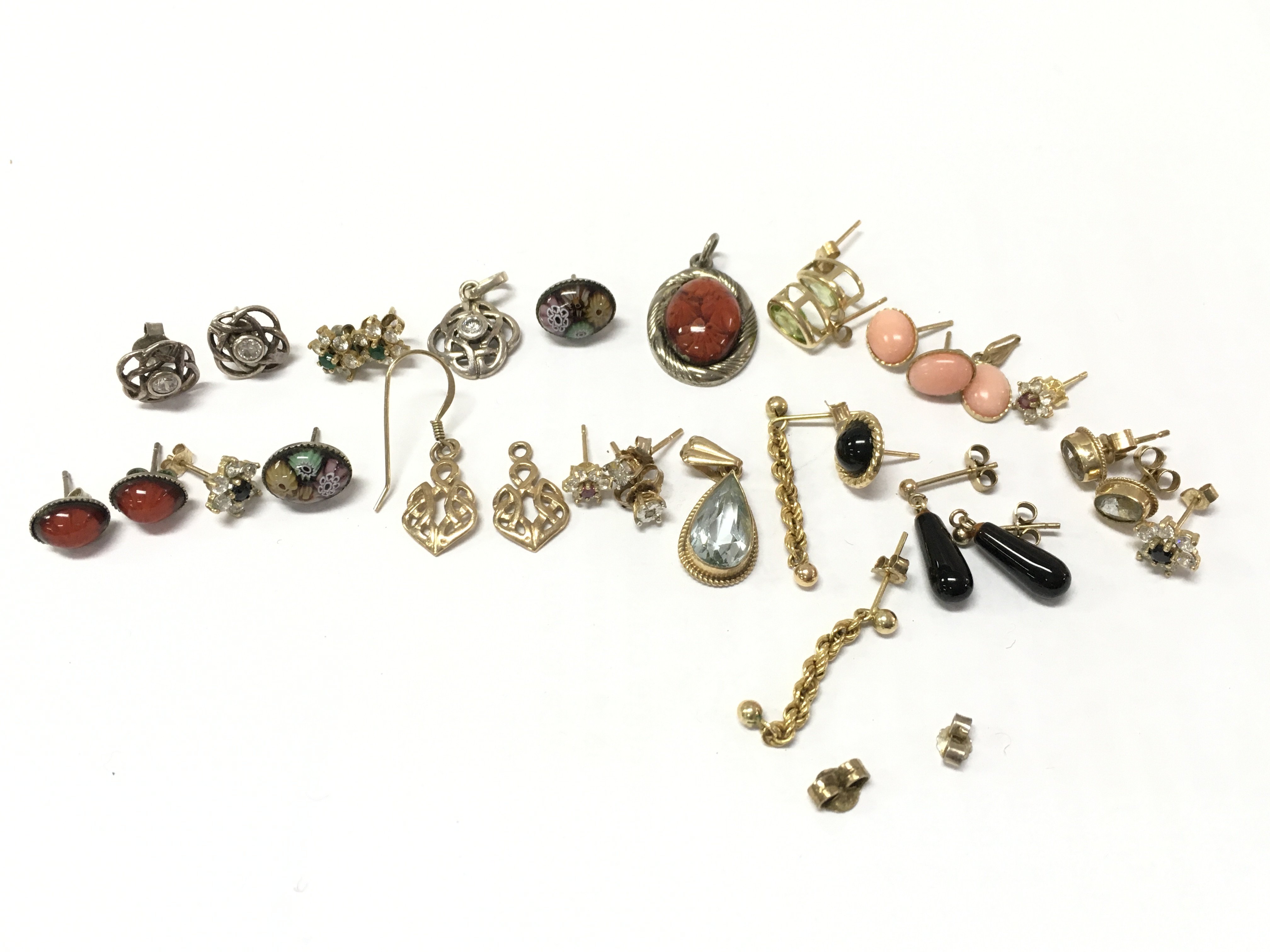 A collection of gold and silver earrings , postage category A