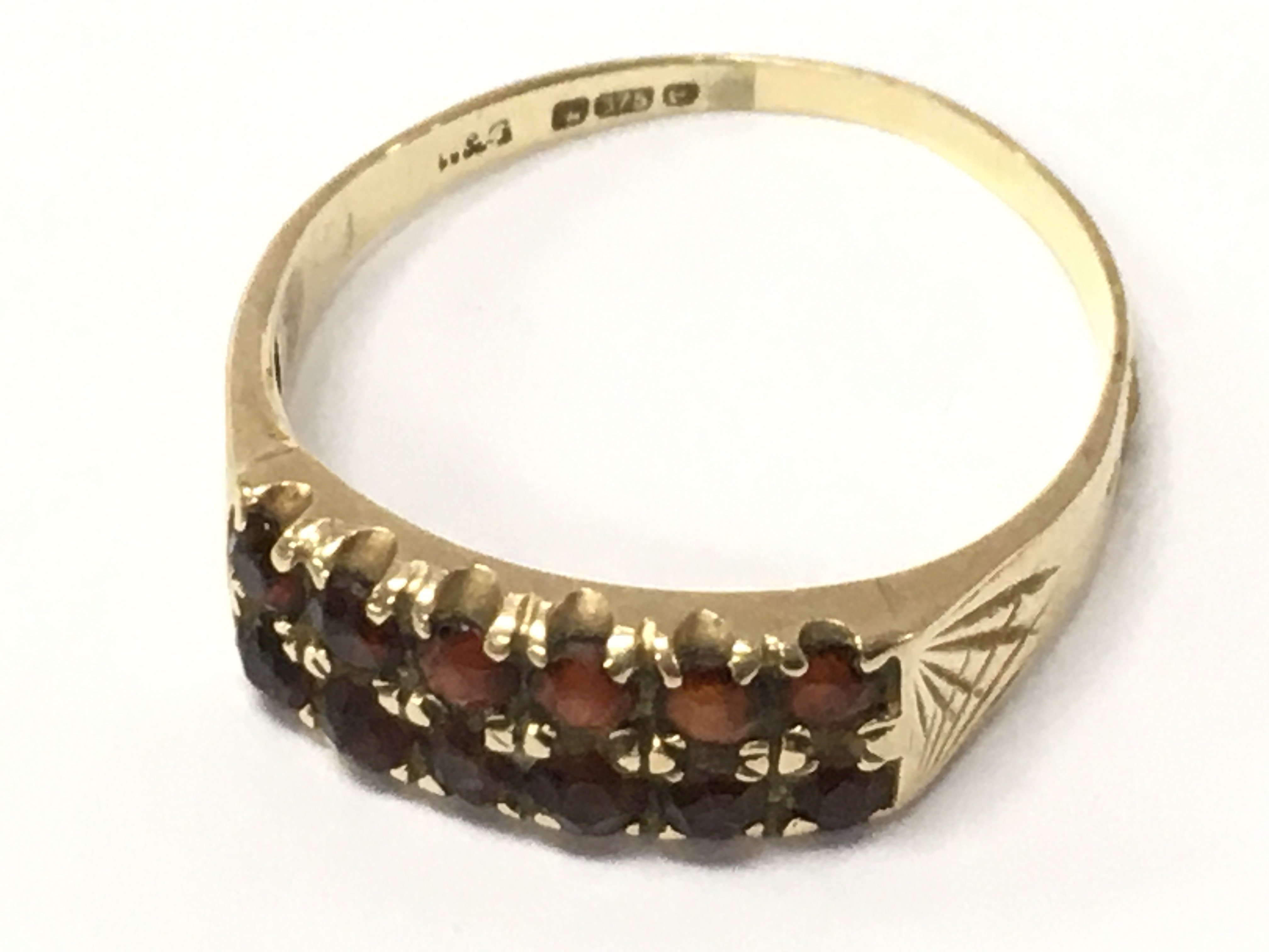 A 9ct gold ring set with garnets , 2.1g total weight. Postage category A