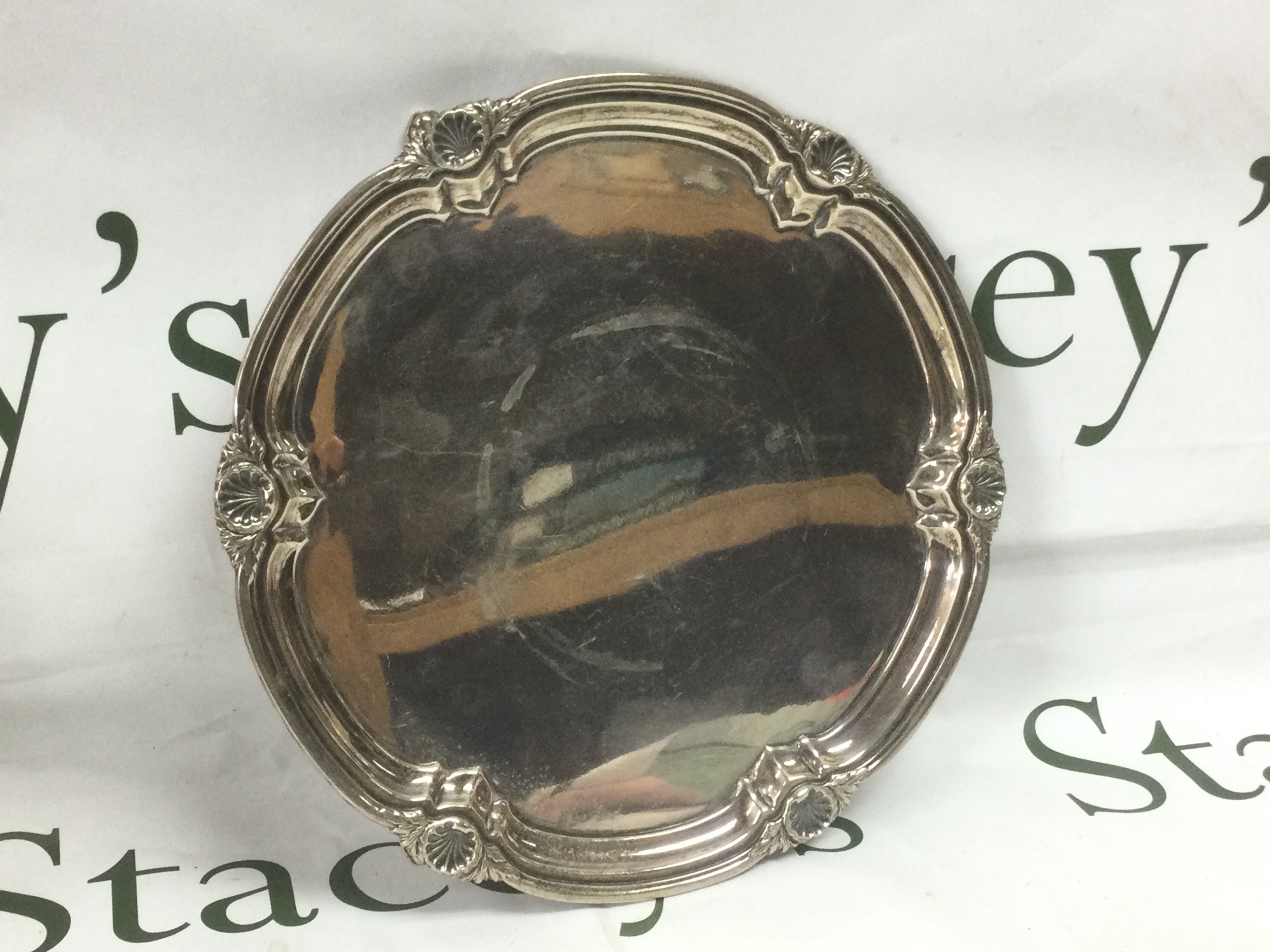 A silver salva, Sheffield hallmarks, approx width 26cm and approx 531g. Shipping category B.