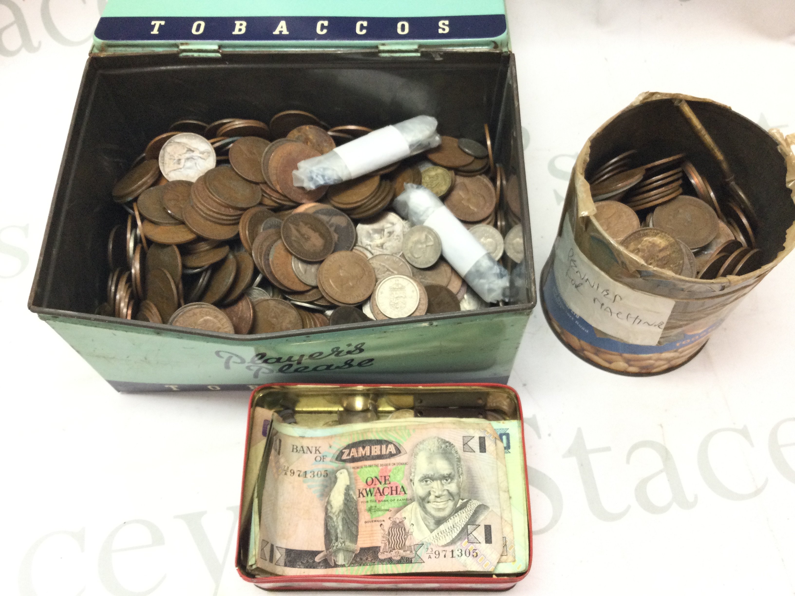 A collection of British coins including pennies and world notes