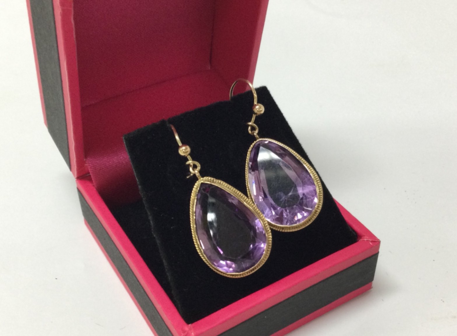 A pair of 9ct gold amethyst earrings, 6.2g total weight . Postage cat a