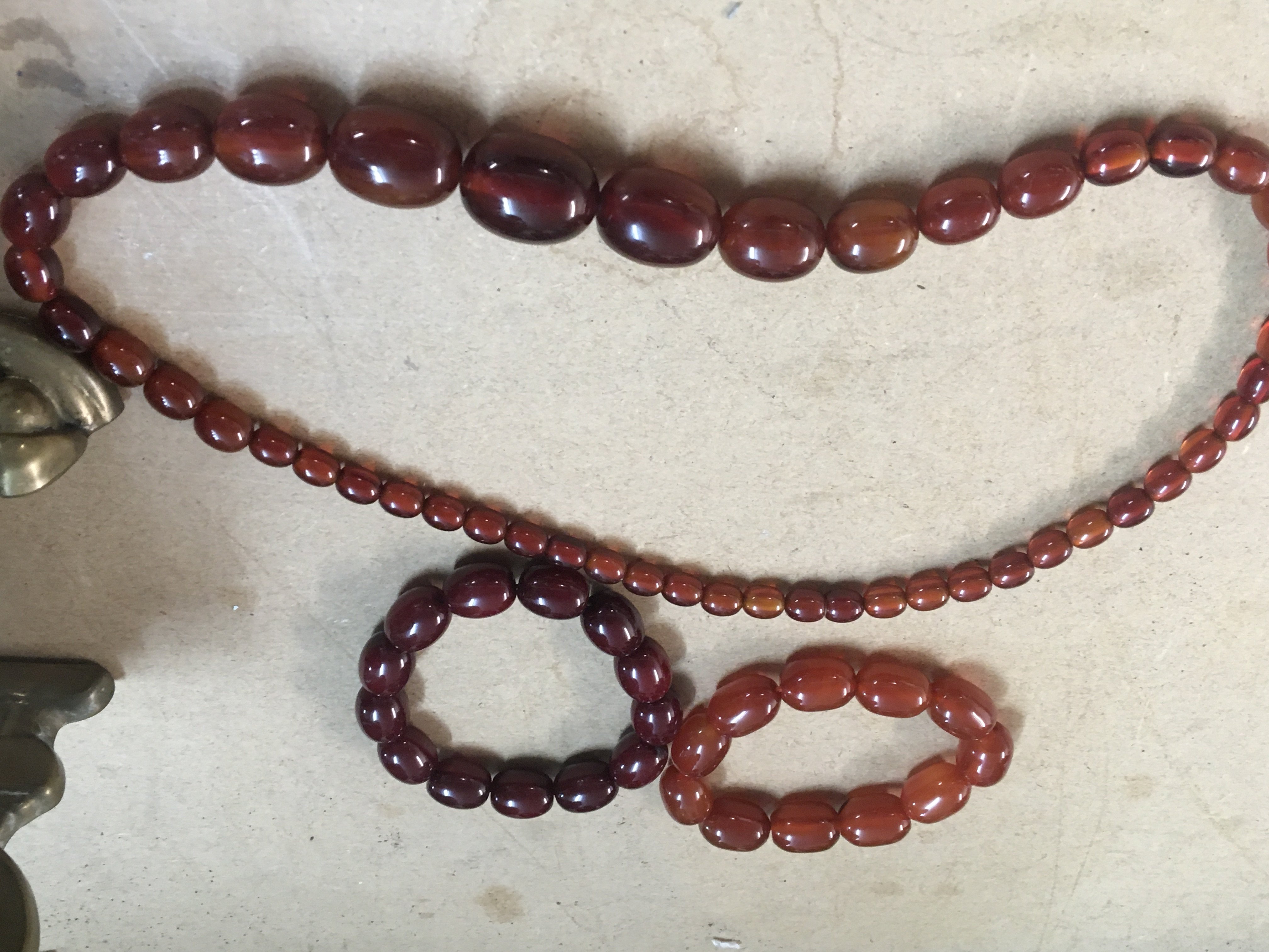 Two Amber bakelite bangles and necklace.