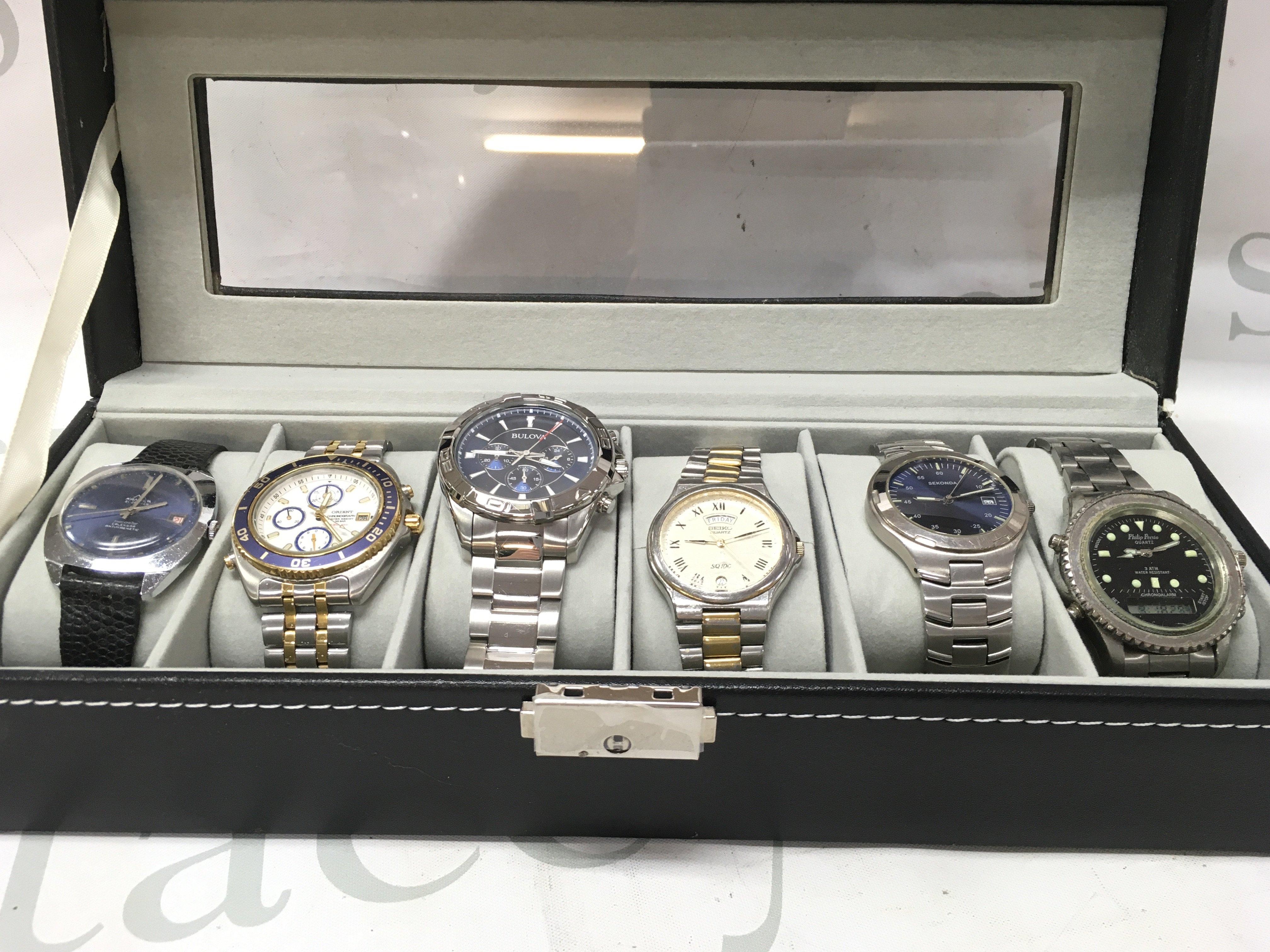 Six gents watches including Sekonda, Bulova, Seiko etc in a display case. seen working