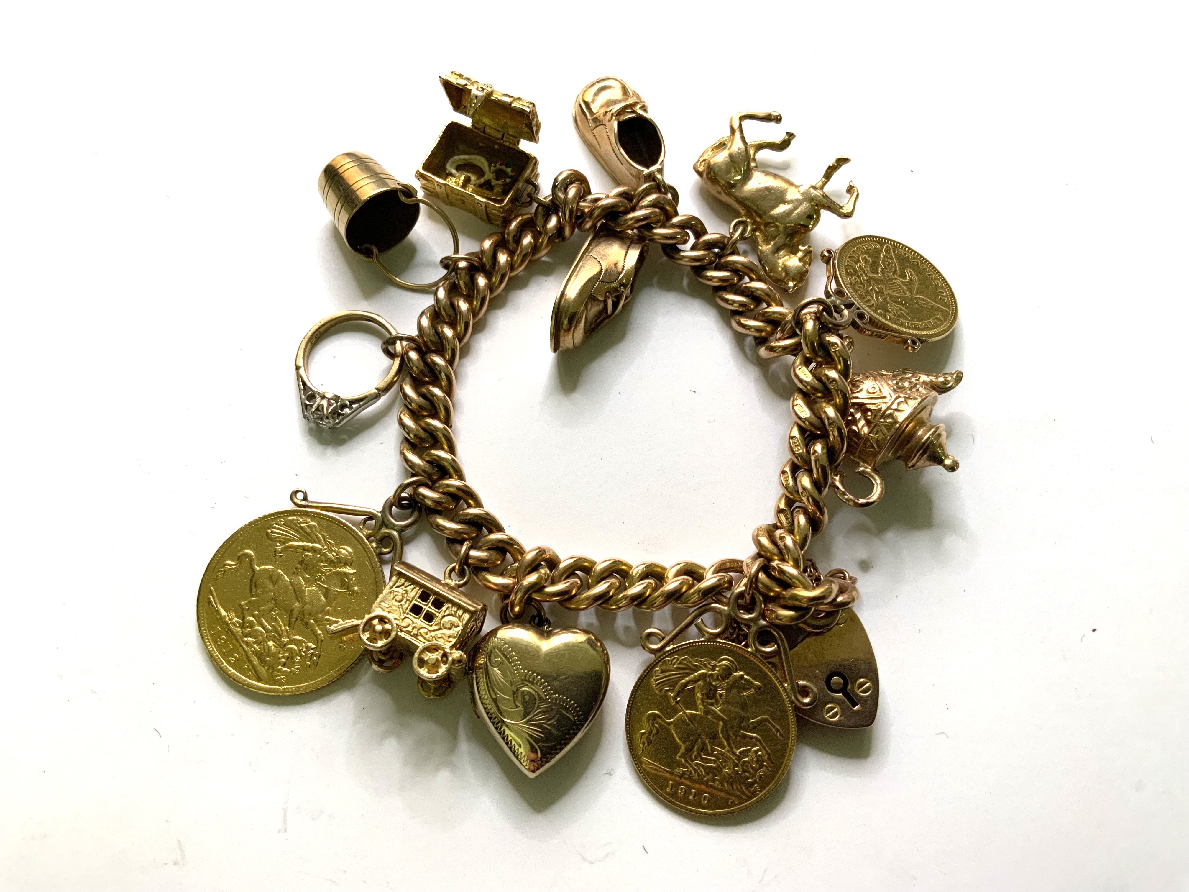 A heavy 9ct gold chain with attached charms, 1912 Full Sovereign, 1910 Half Sovereign, 1873 2.5 dollar piece. 75.6g
