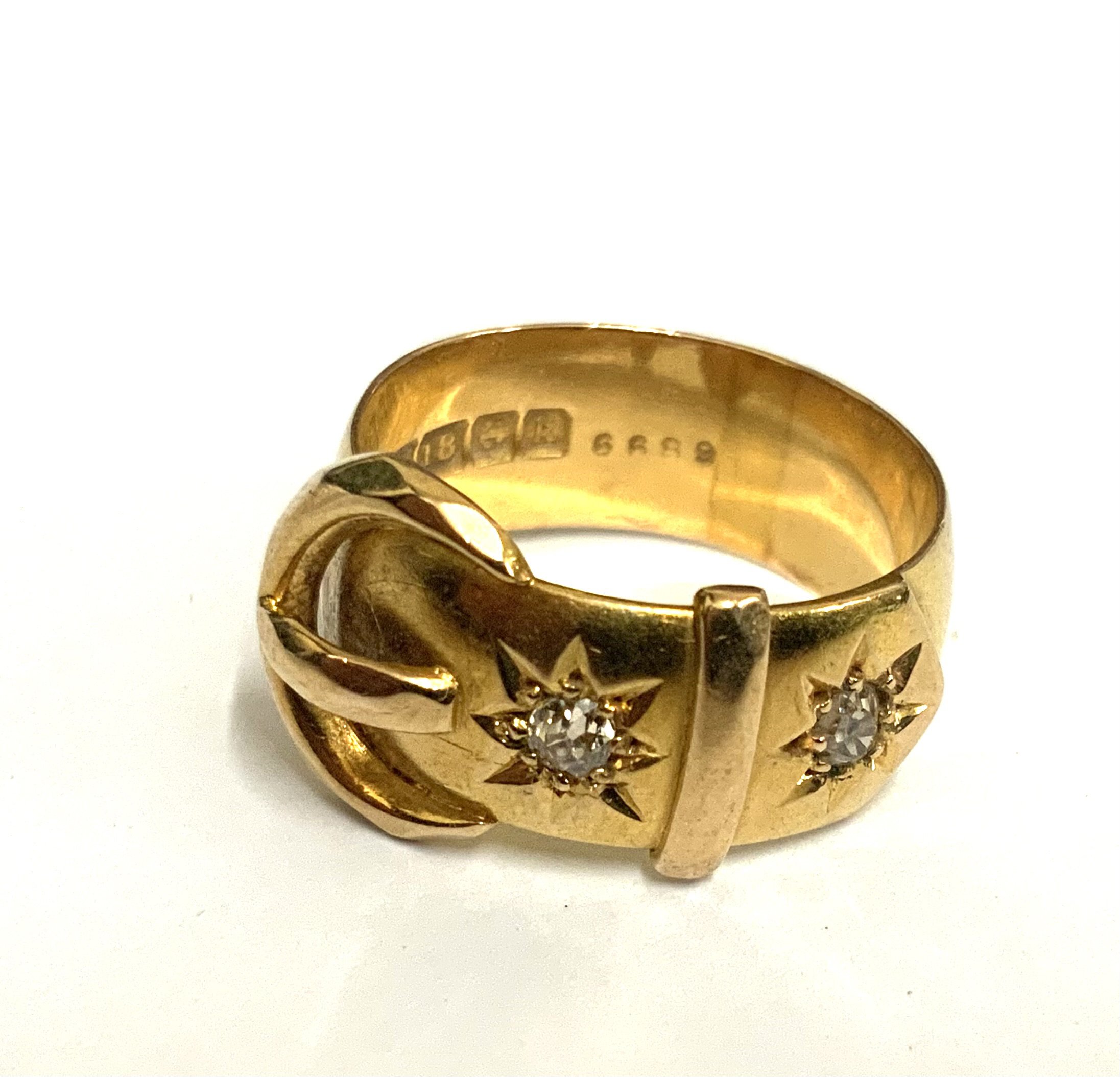 An 18ct yellow gold belt and buckle design ring inset with 2 old cut diamonds .c.1910, Size L. 6.7g.