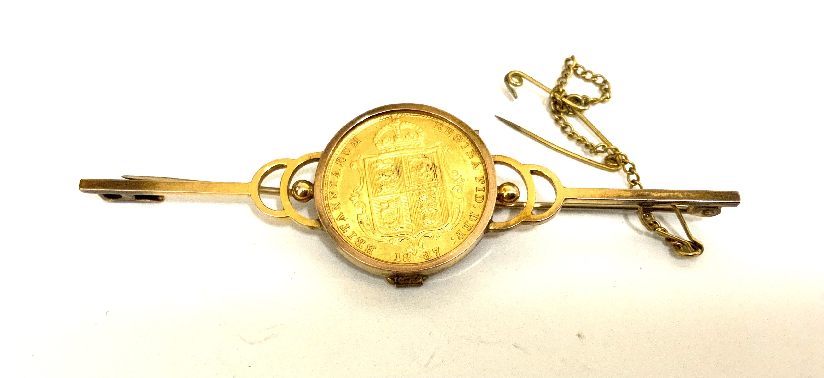 An 1887 Shelid back half sovereign with a 9ct gold brooch coin mount. (A)