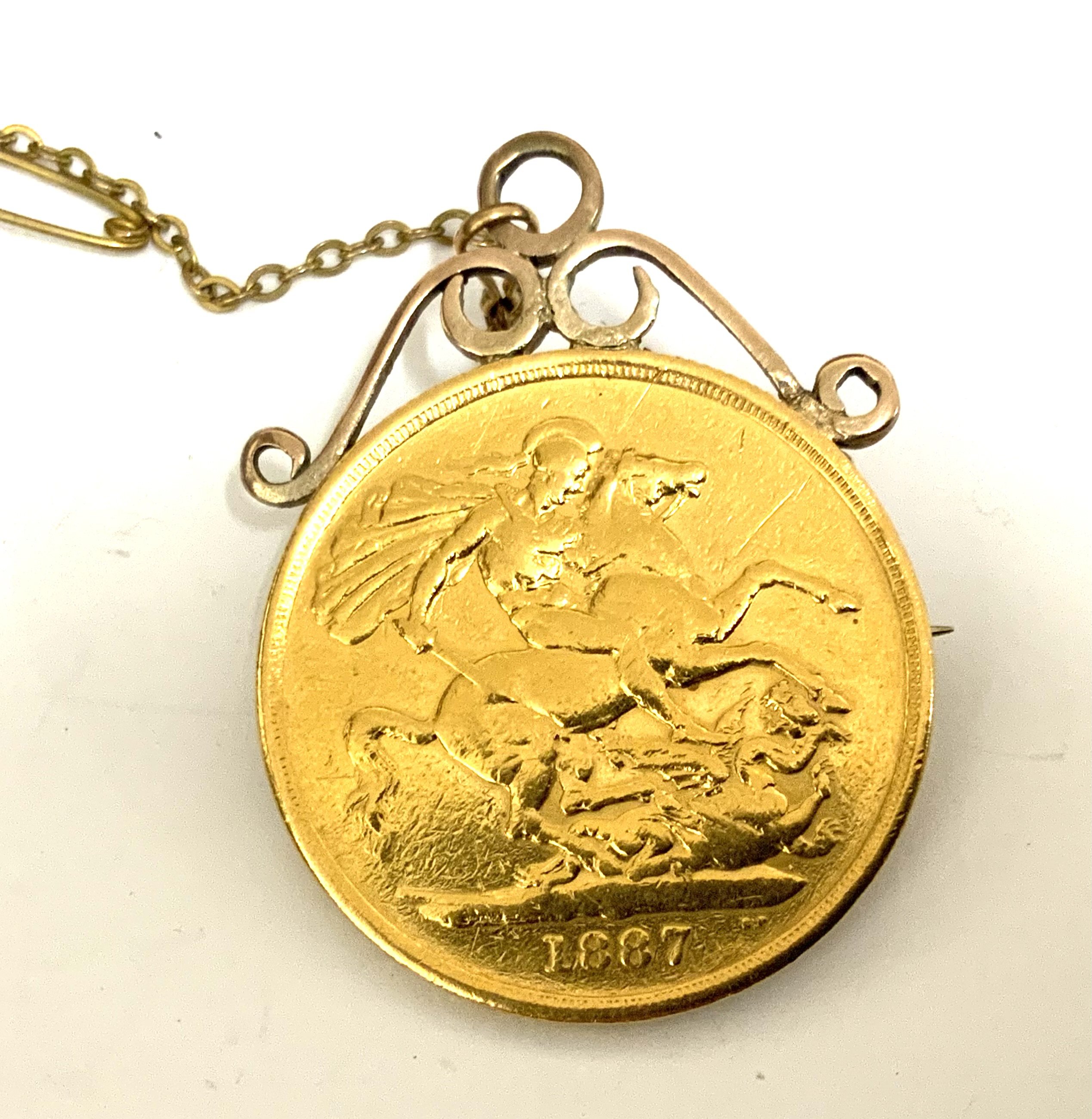 An 1887 Double Sovereign with soldered mount and pin/saftey chain. 17.8g (A)