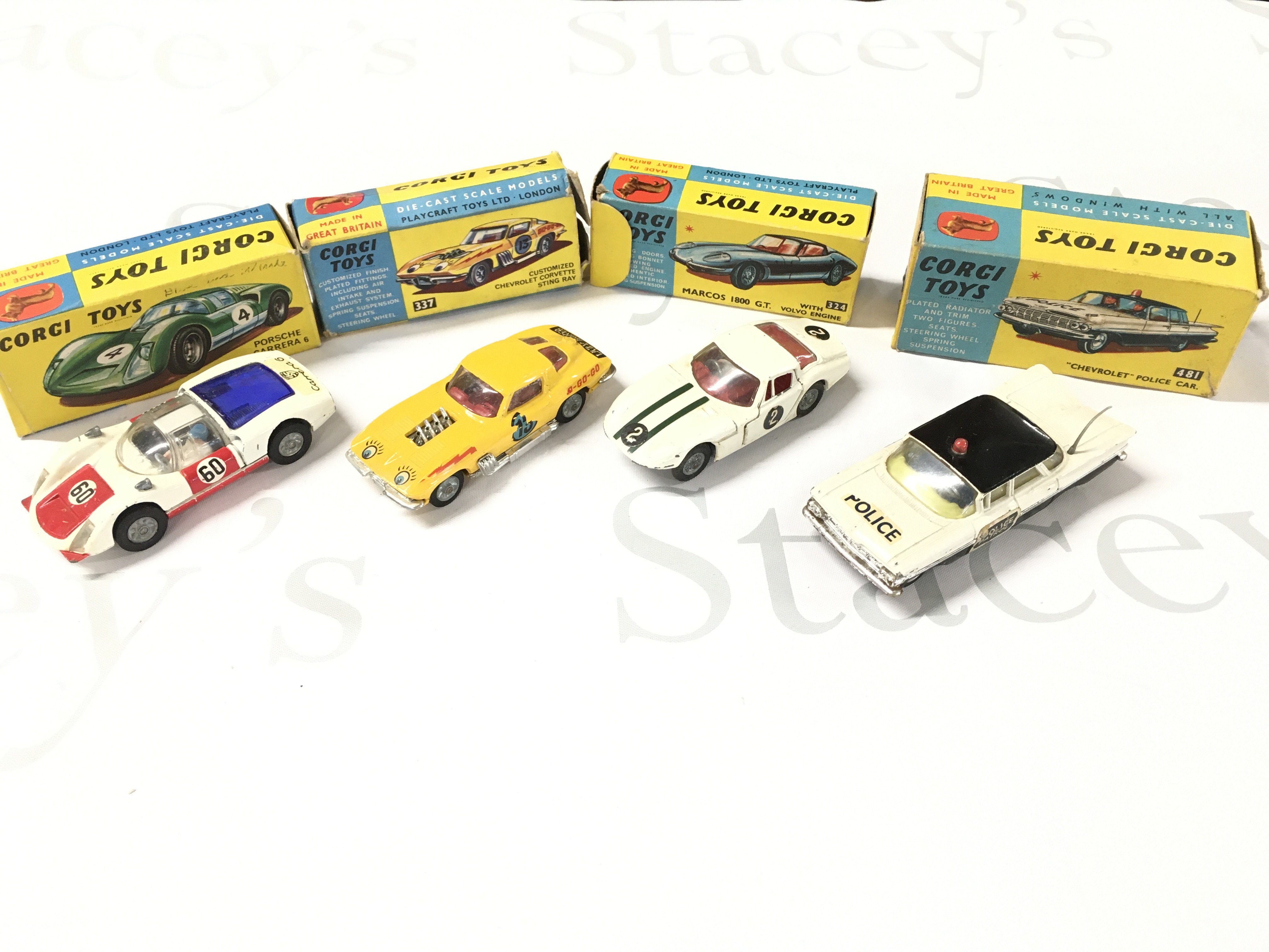 4 X Boxed Corgi Vehicles. A Porsche Carrera #330. A Customized Chevrolet Chevrolet Corvette Sting Ray #337. A Marcos 1800 G.T #324 And A Chevrolet Police Car #481.