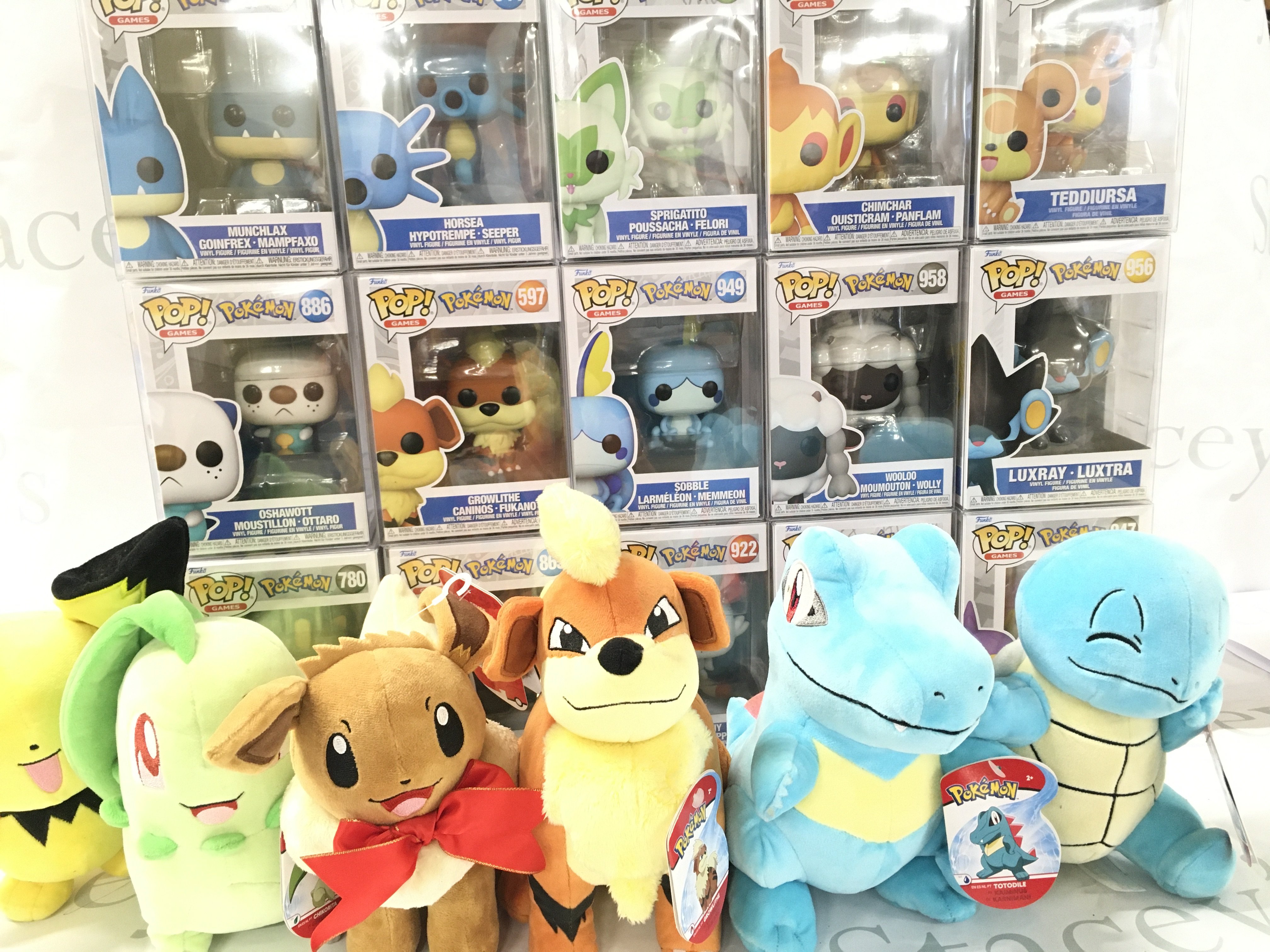 A Collection of Boxed Funko Pop Figures all Pokemon And Pokemon Soft Toys.