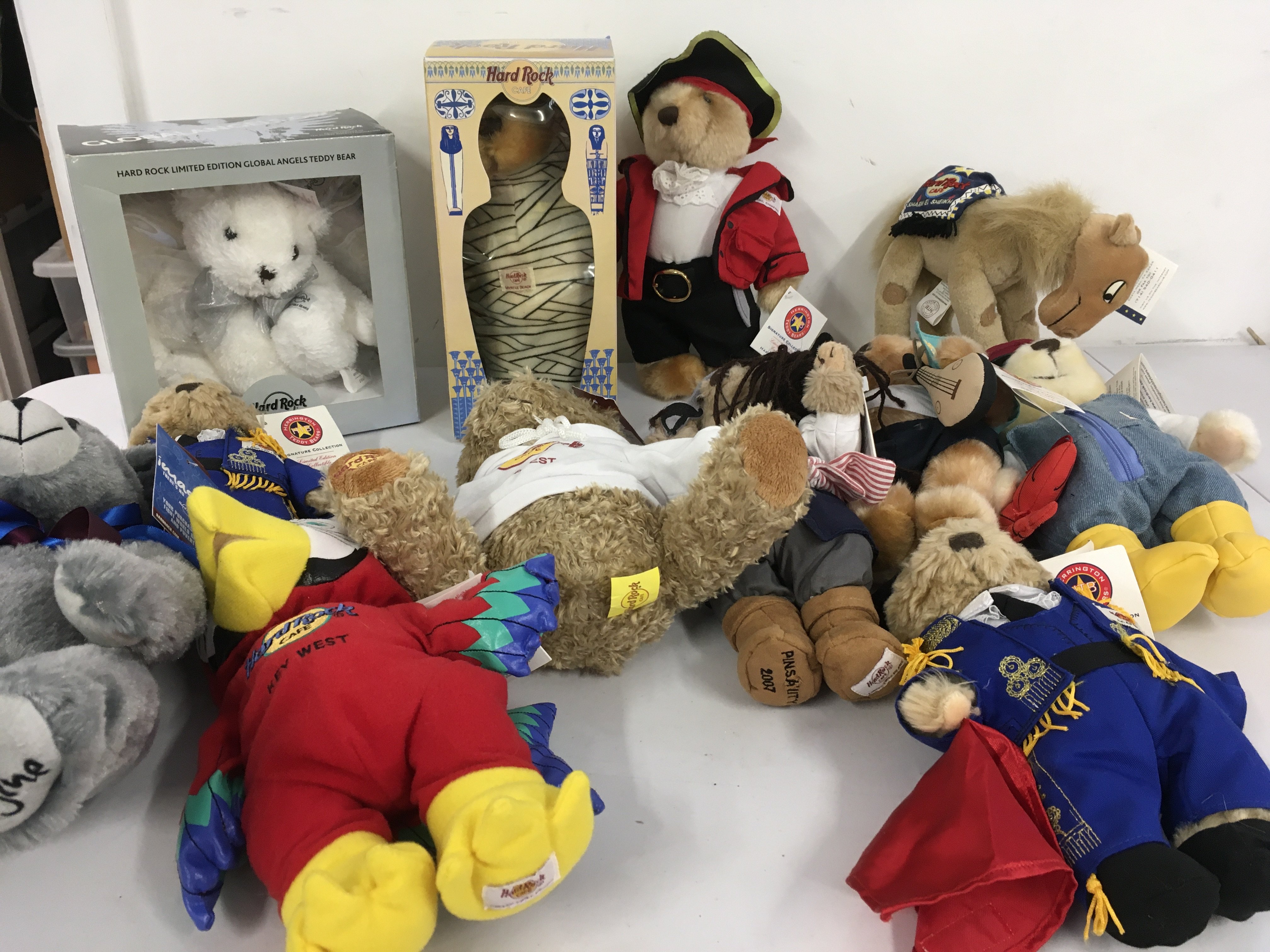 A collection of 12 Hard Rock Teddy Bears with tags. includes John Lennon IMAGINE bear. No reserve