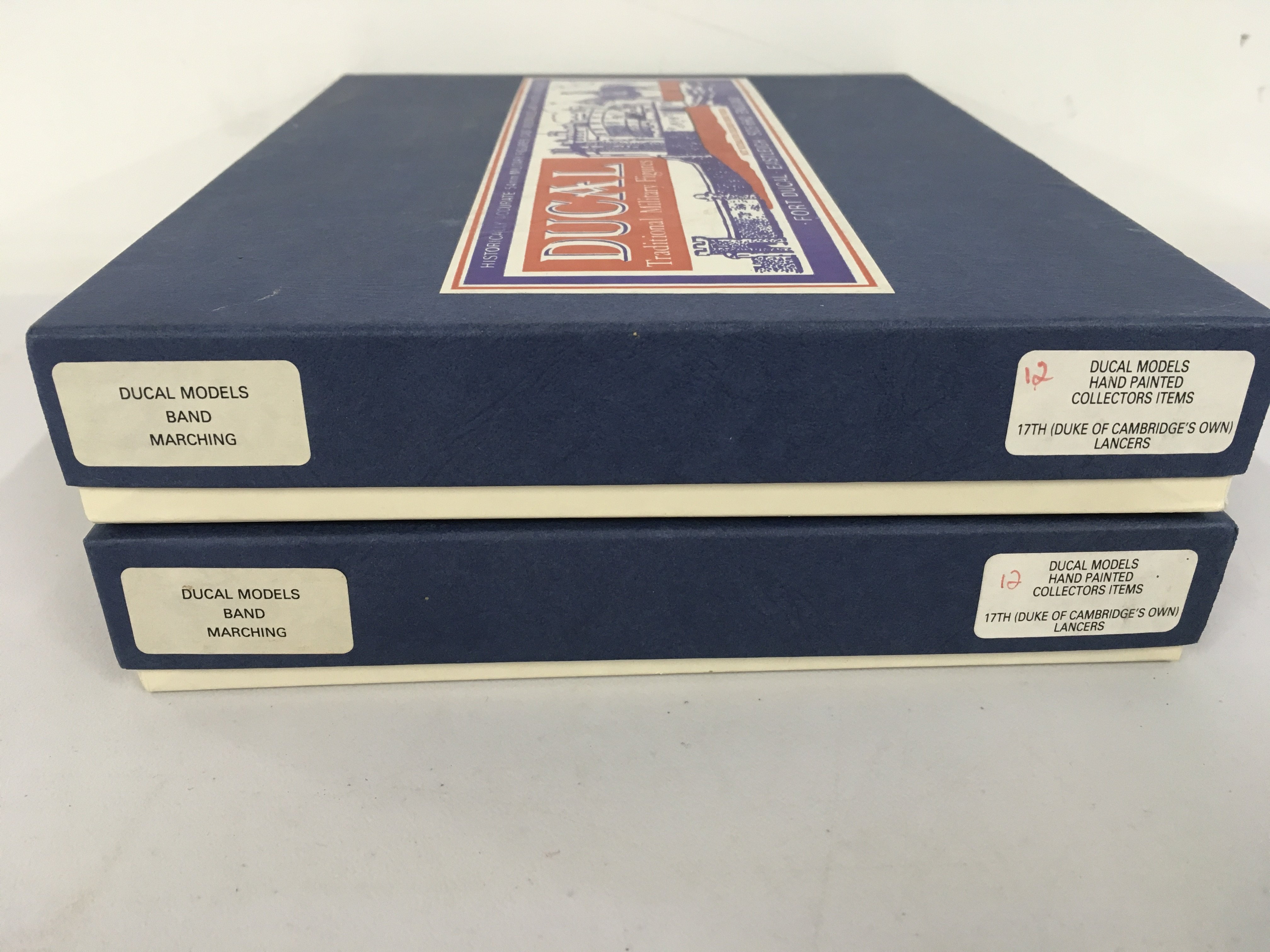 2 boxed Ducal metal military miniature figures featuring the marching band of 17th Duke of Cambridges Own Lancers. No reserve